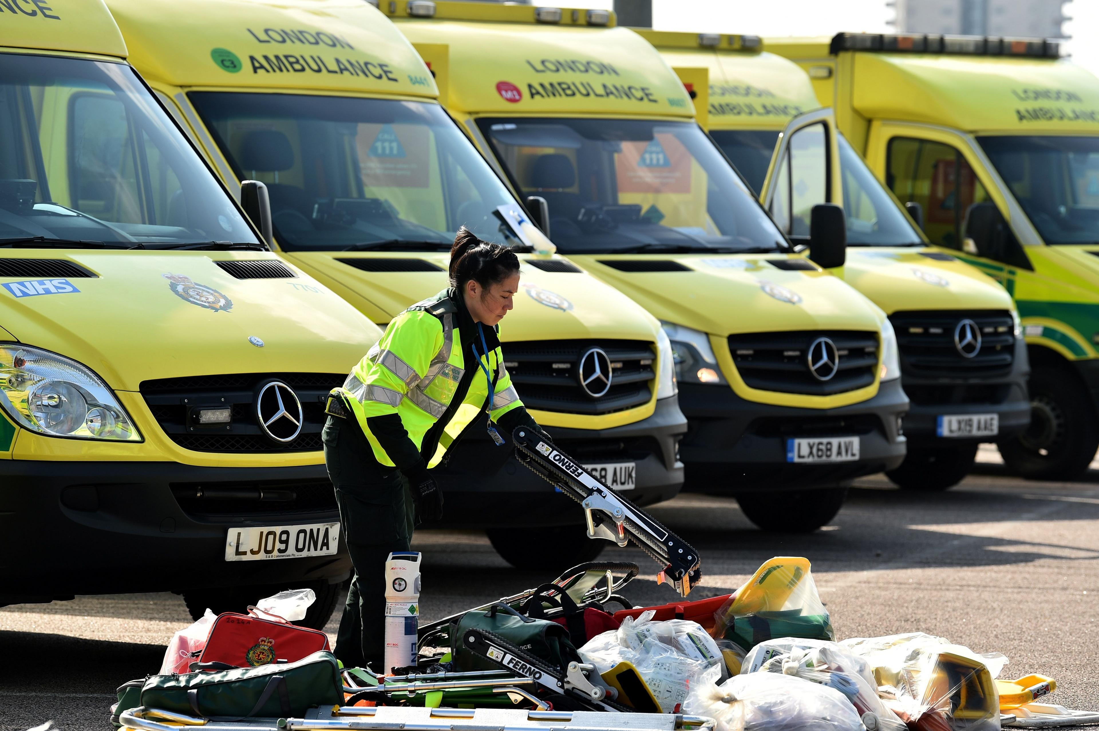 A worker moves medical equipment outside the NHS Nightingale Hospital