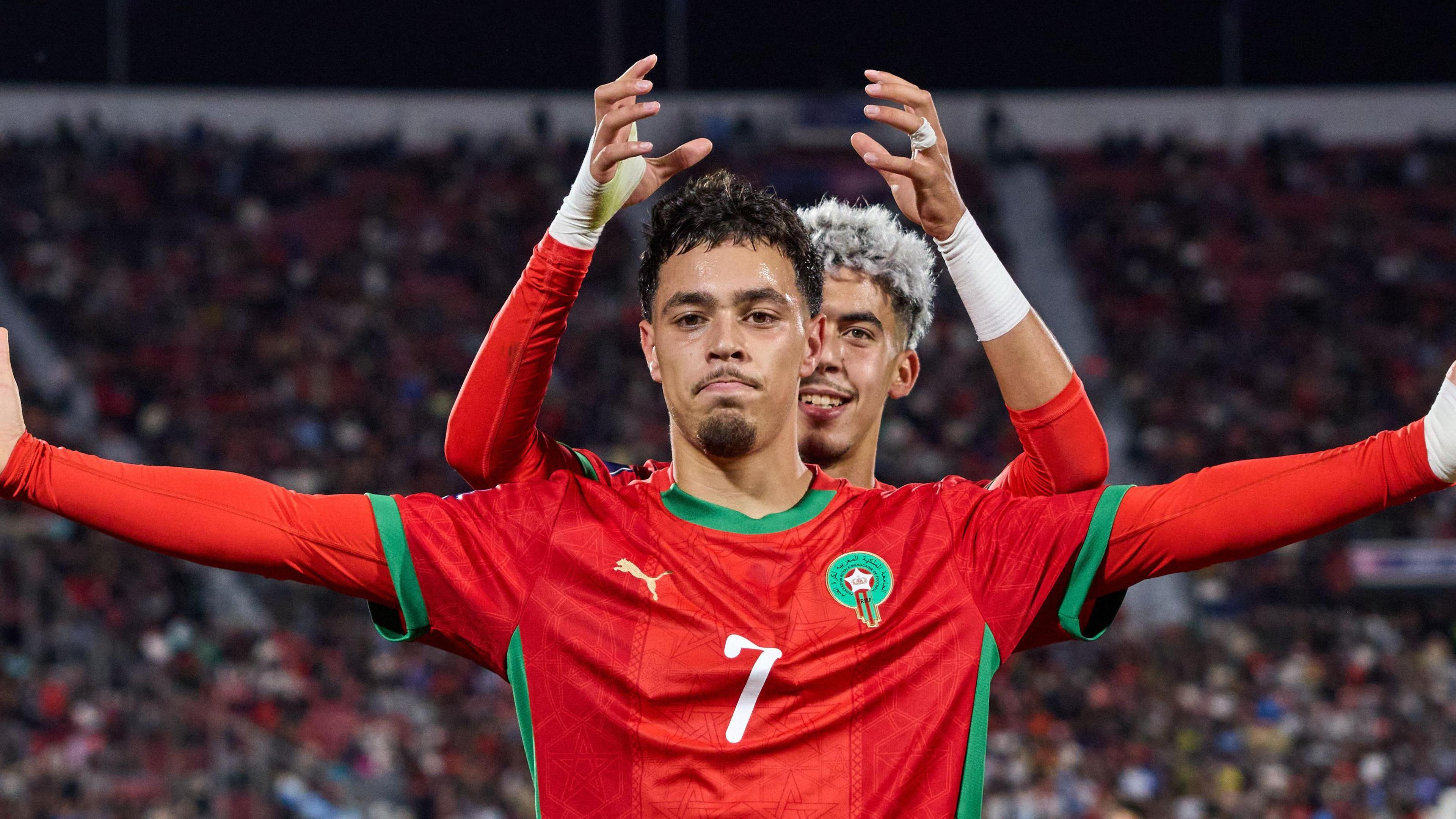 A picture of Morocco's Othmane Maamma celebrating with team-mate Yassir Zabiri