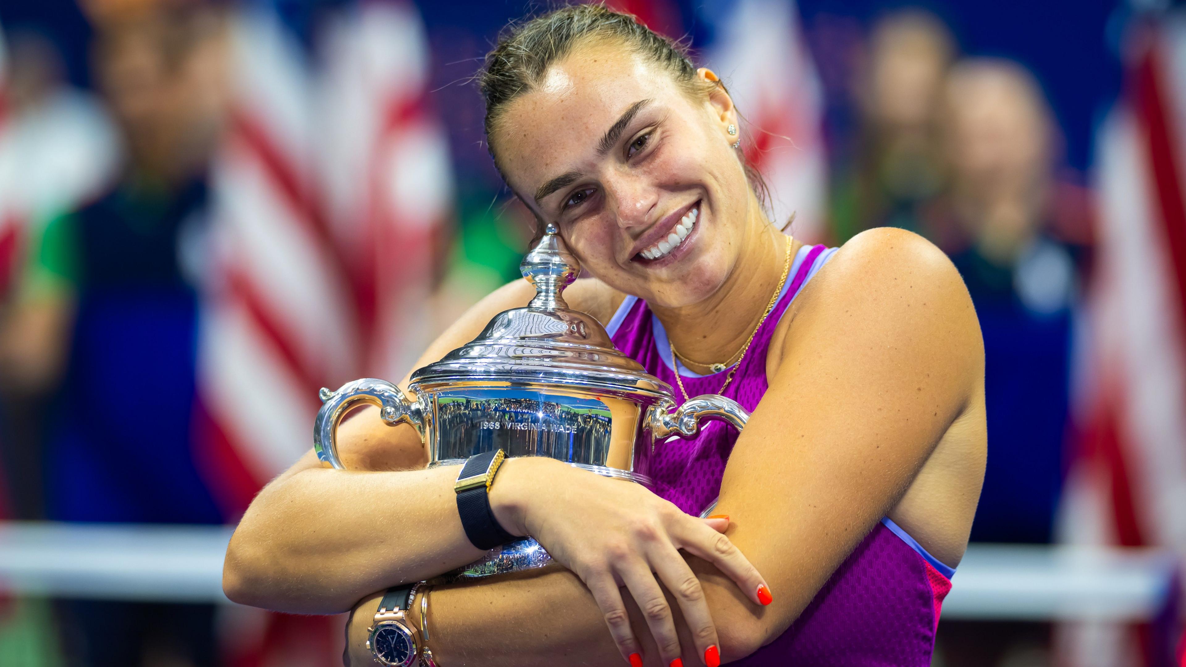 Aryna Sabalenka hugs the US Open trophy after her victory in 2024