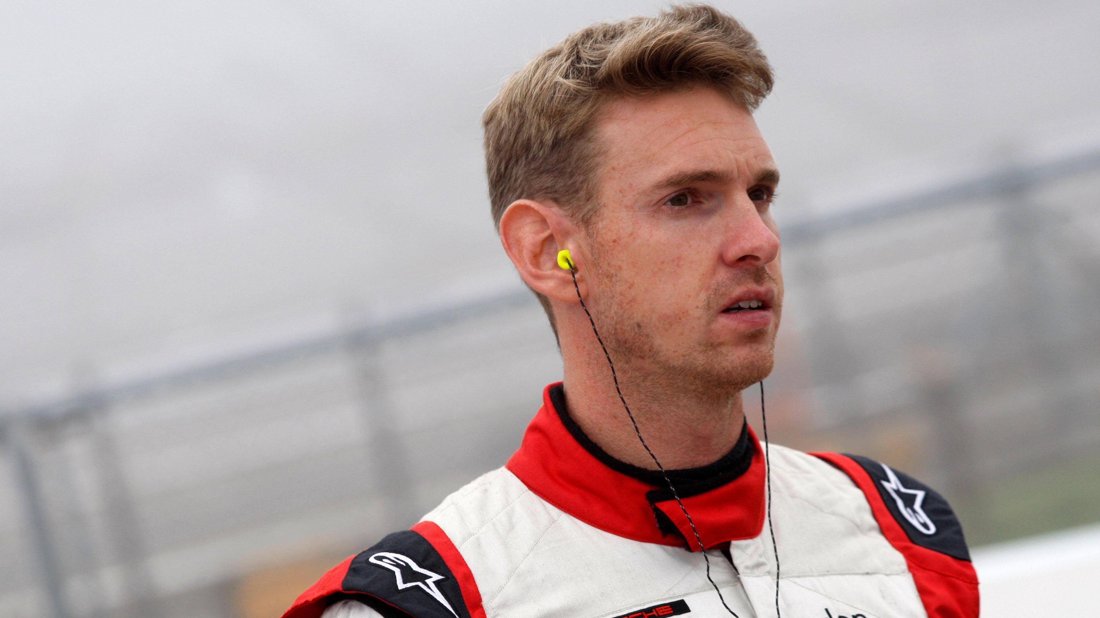 Paul Rees in racing driver's overalls and earphones, pictured at the Porsche Carrera Cup, Rockingham, 6th-7th September 2014