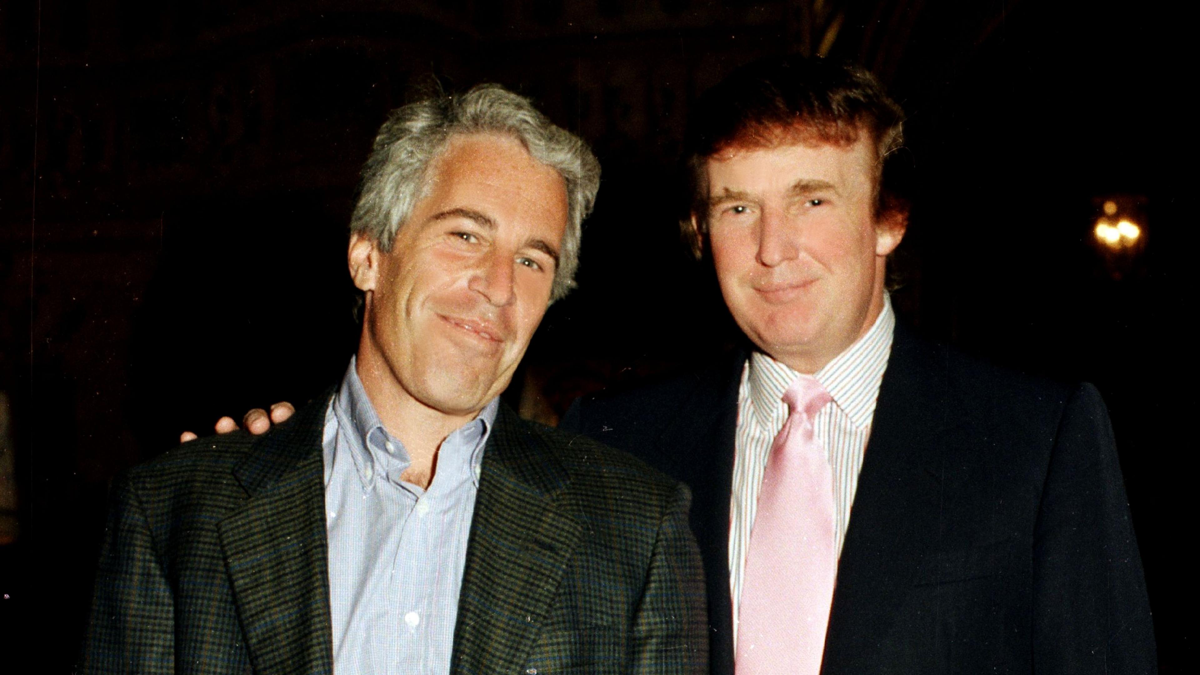 Jeffrey Epstein and Donald Trump pose for a photo together in 1997 with Trump putting his right hand on Epstein's left shoulder.