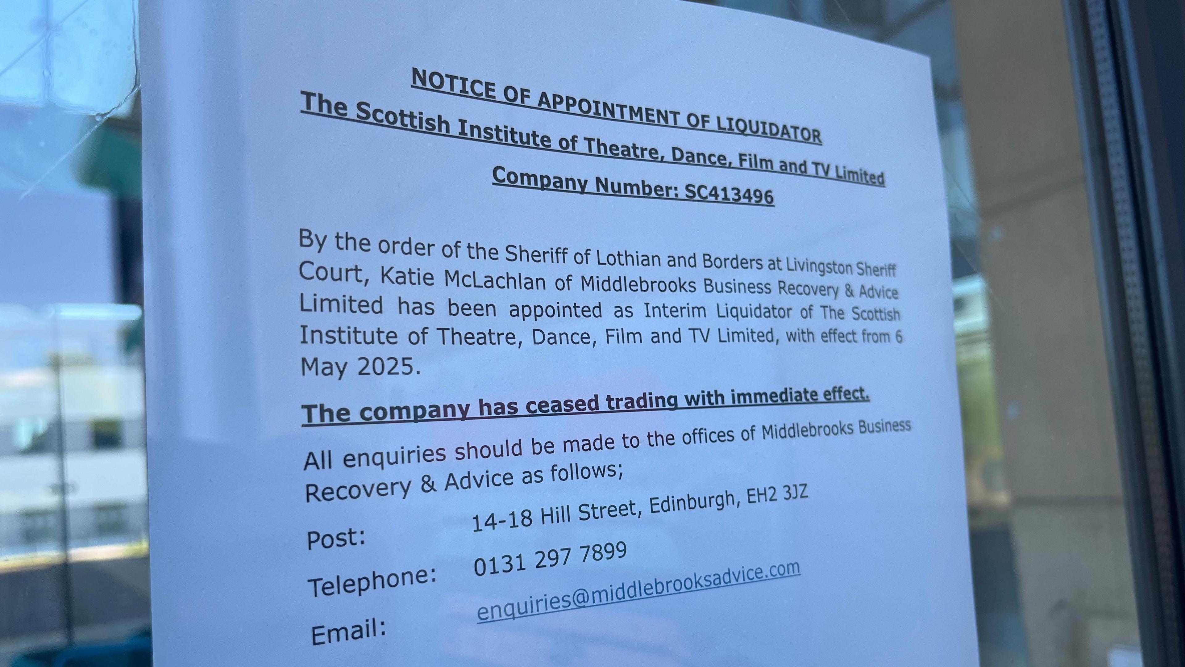 A liquidation notice stuck to the door of the Scottish Institute of Theatre, Dance, Film and Television.