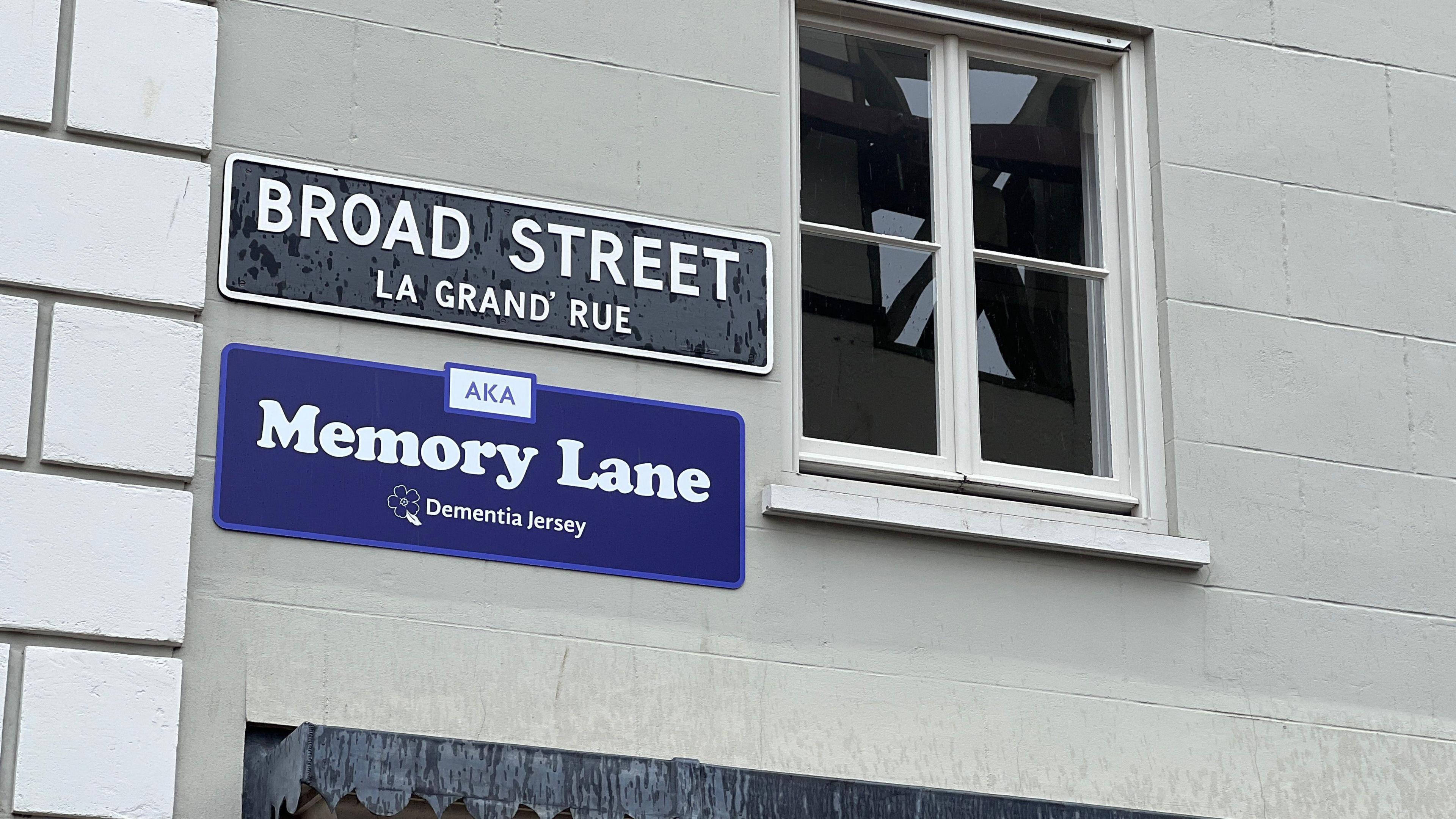 The road sign for Broad Street has another sign underneath it saying Memory Lane