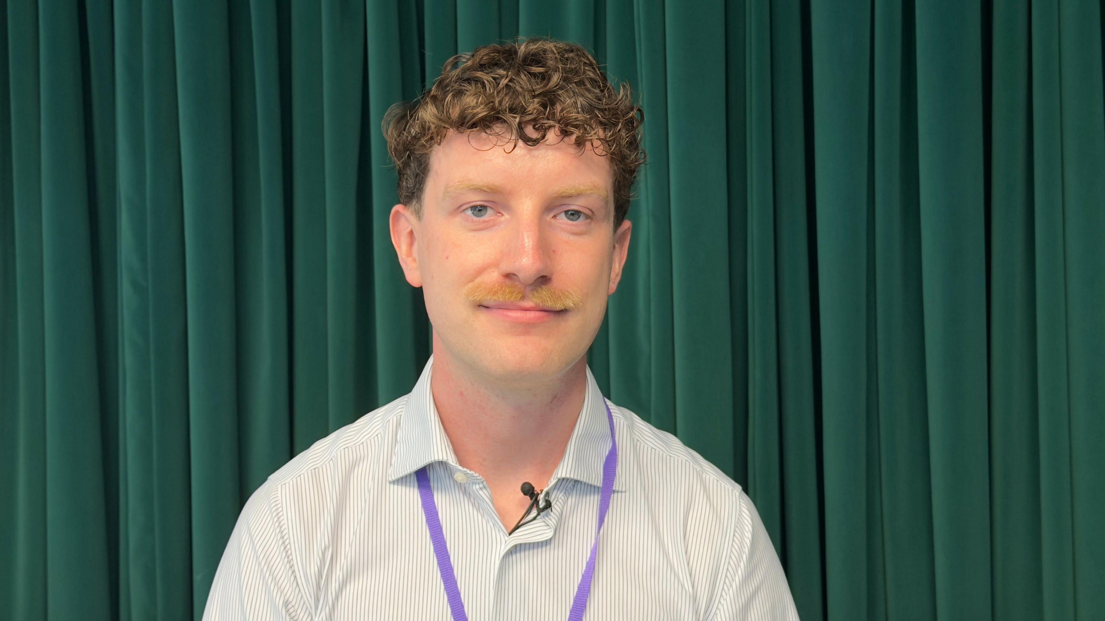 Tom Cantillon sat in an office looking at the camera