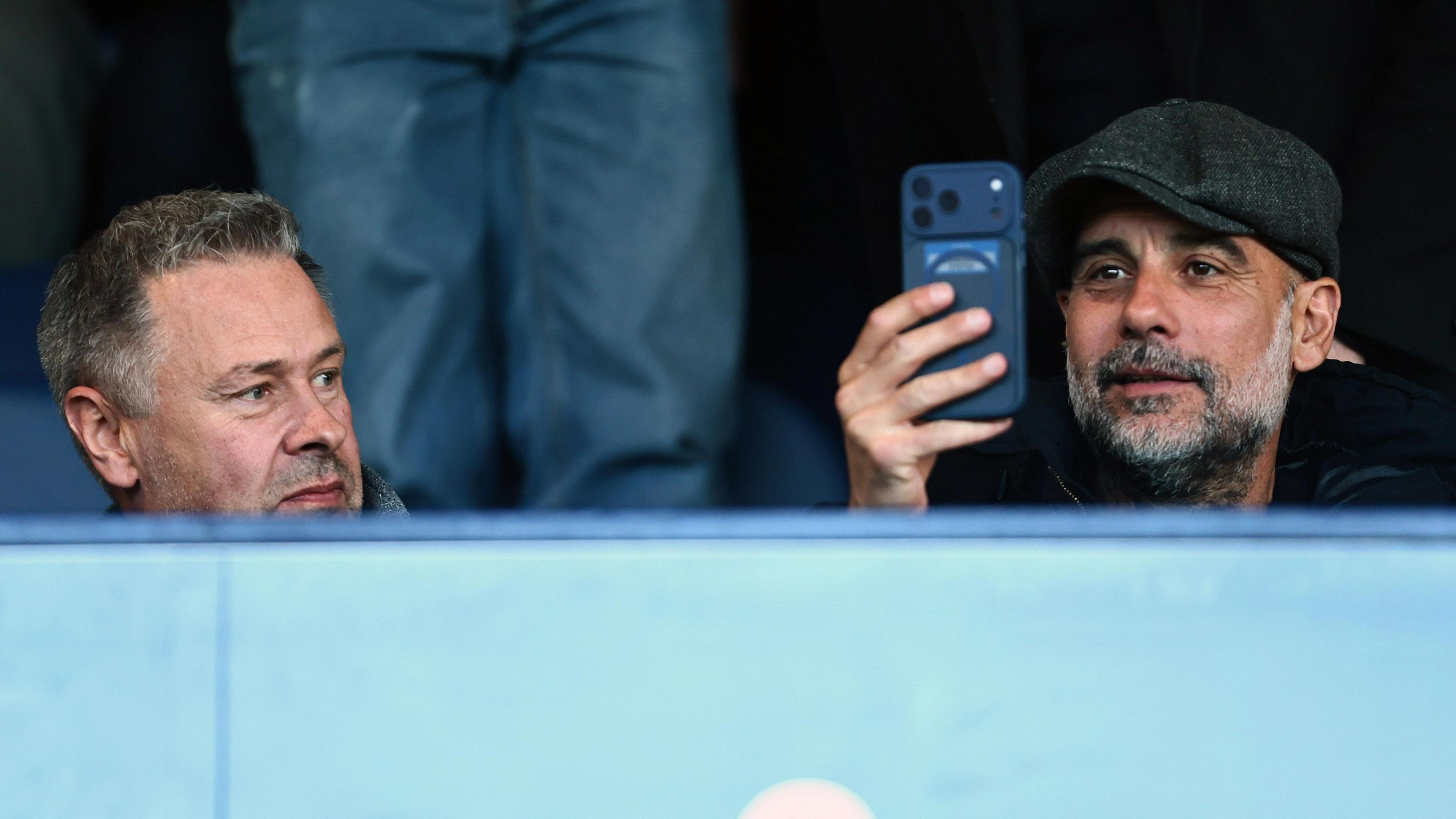 Manchester City manager Pep Guardiola (right) alongside Stockport owner Mark Stott (left)
