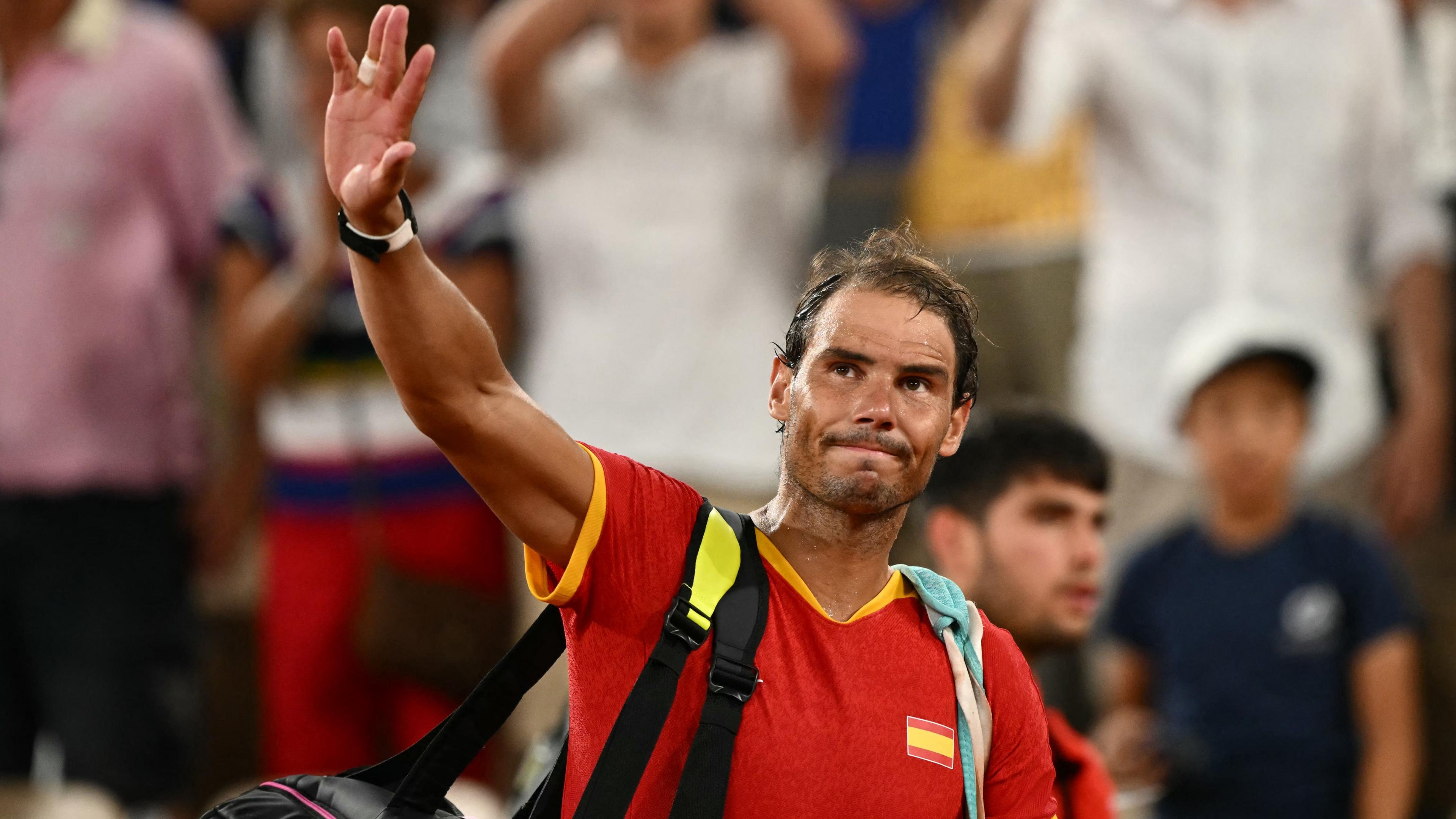 Rafael Nadal waves to the crowd at the Paris Olympics in 2024