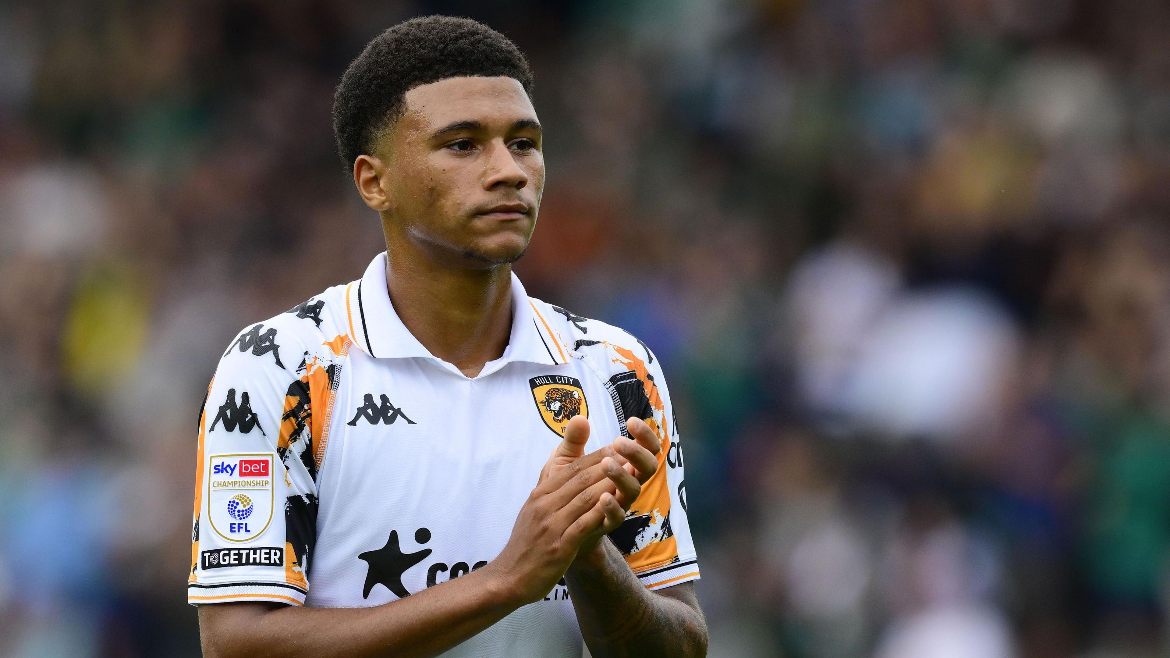 Hull City forward Mason Burstow applauds the fans.