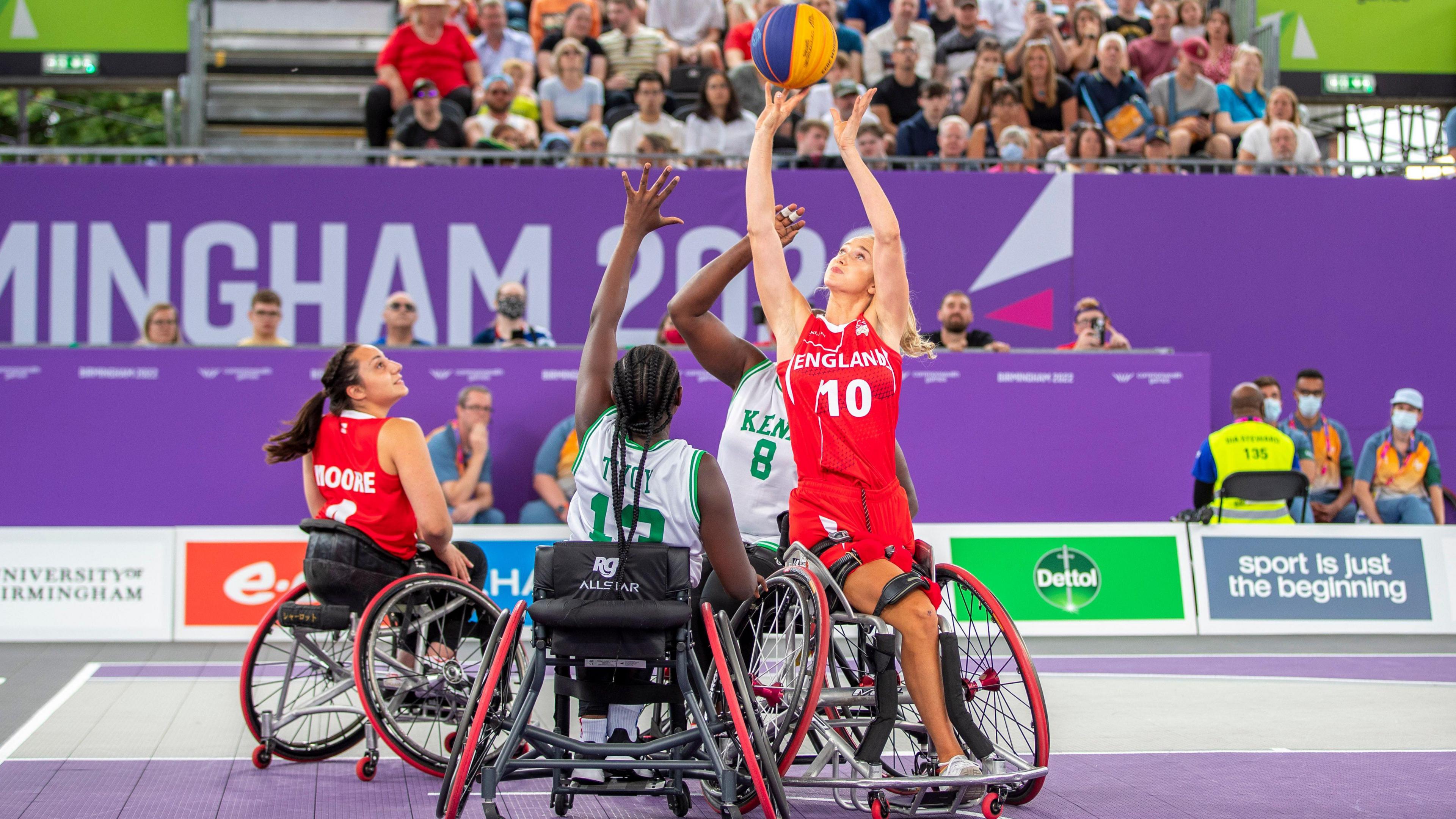 Amy Conroy playing fighting for the ball from the opposition team while playing wheelchair basketball