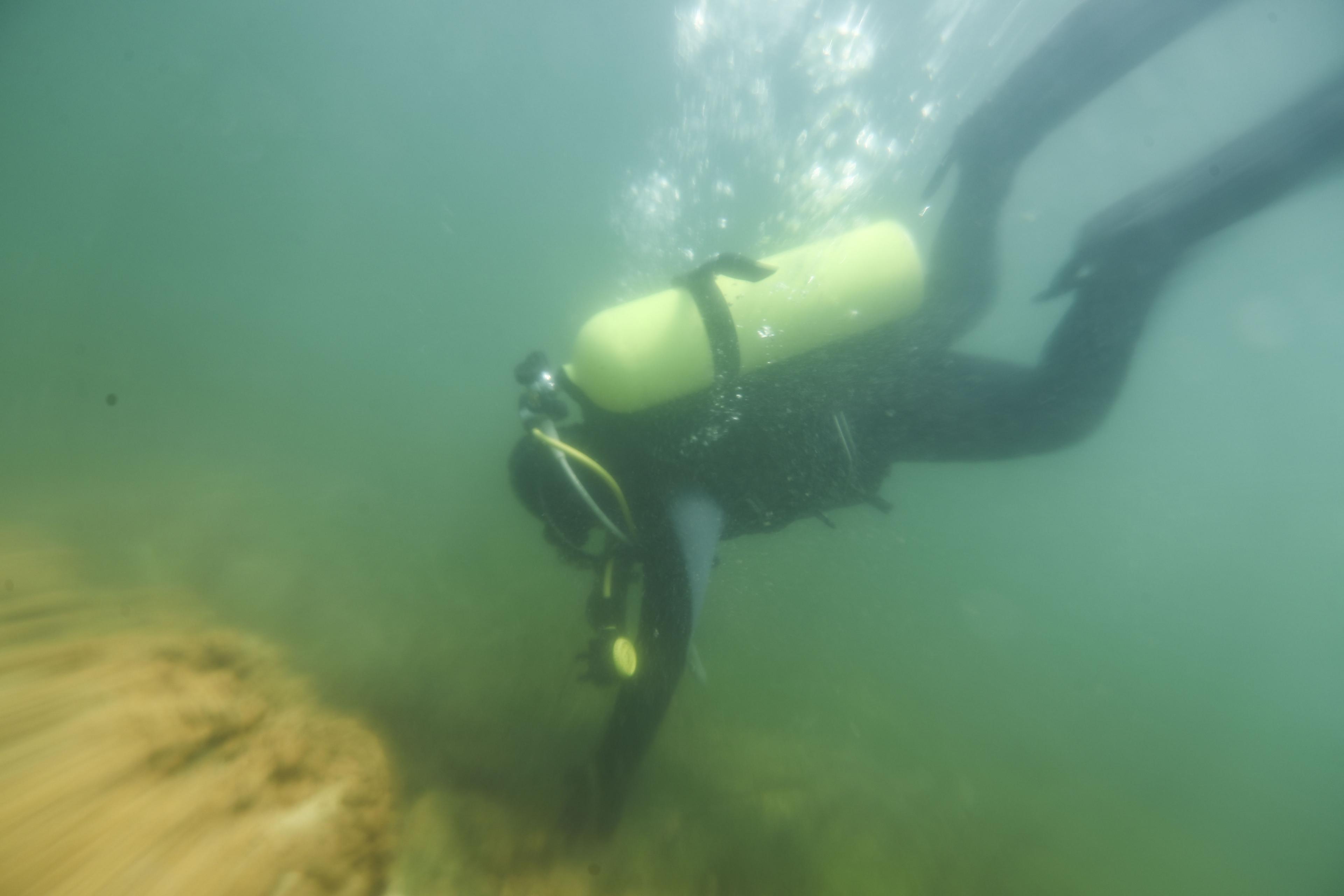 A diver examines an underwater structure in Lake Titicaca