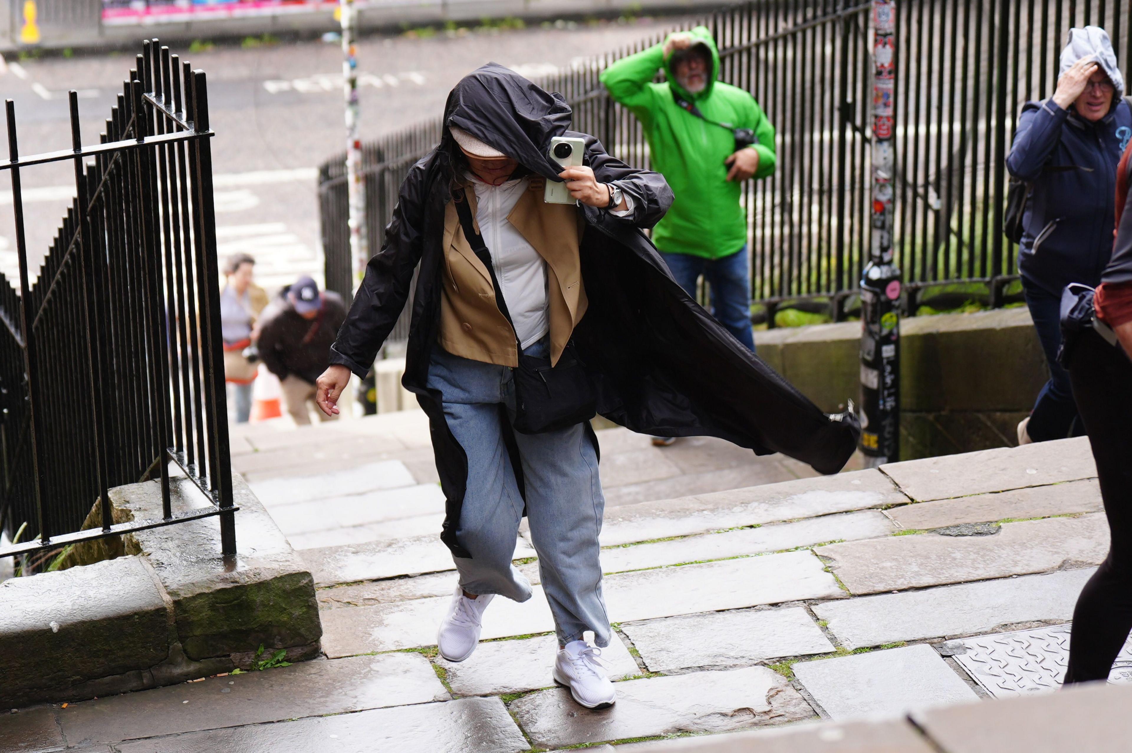 Members of the public battle against the wind as they walk along the Royal Mile, Edinburgh