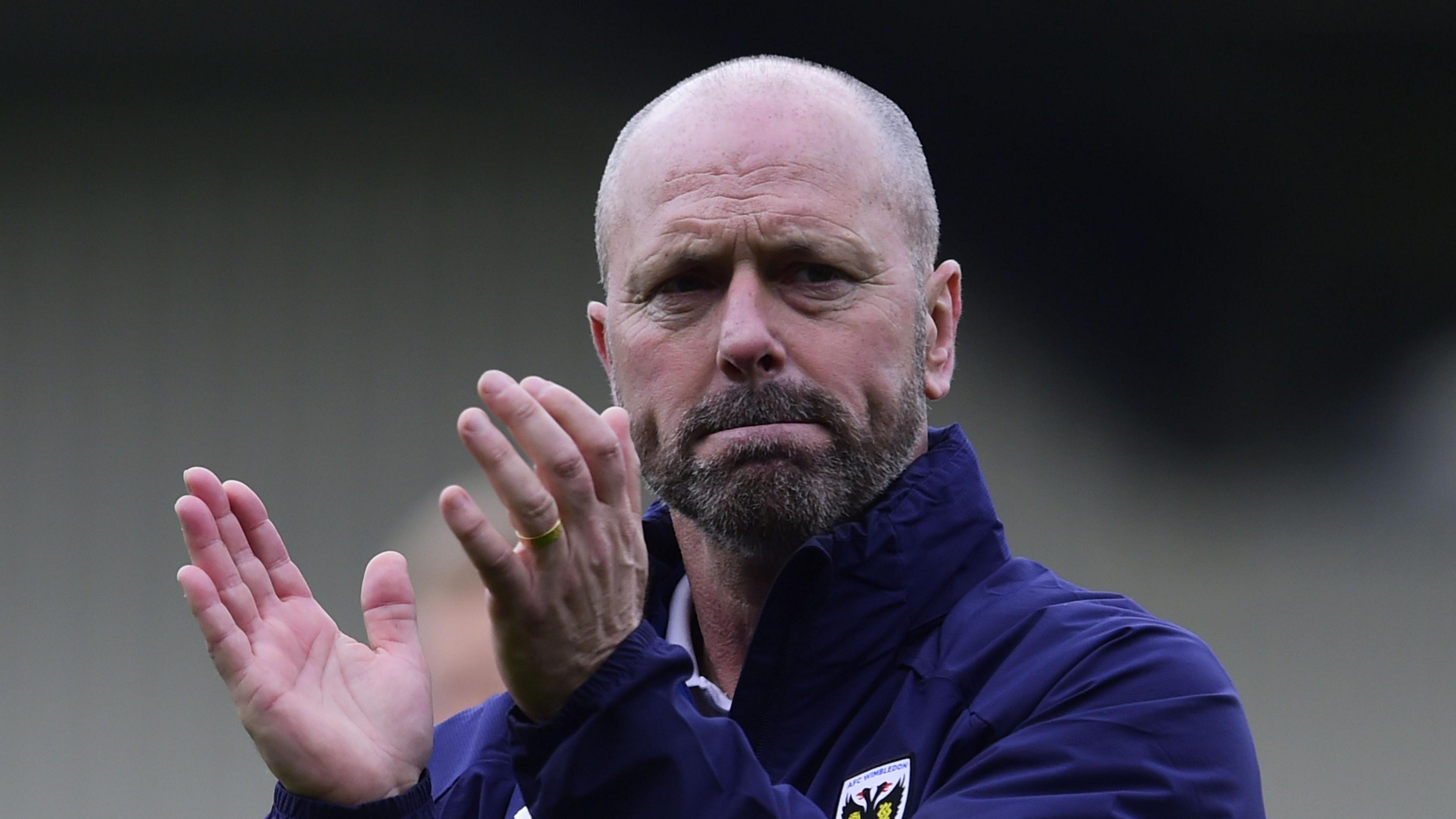 Mark Bowen claps towards fans during his time at AFC Wimbledon