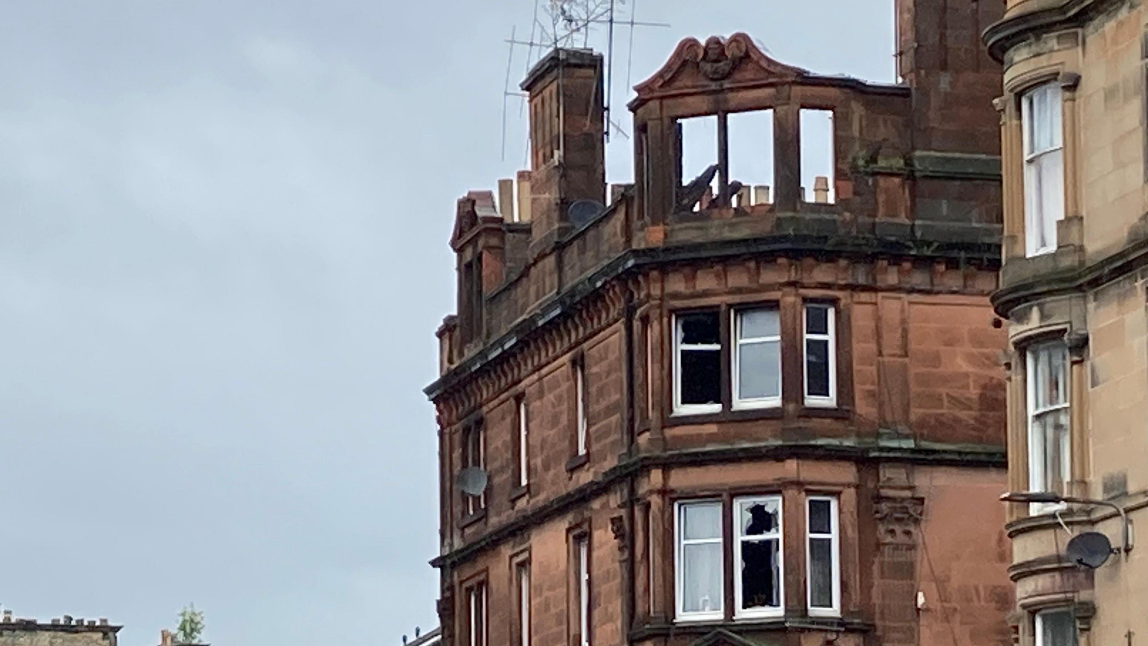 A tenement block in Perth which has been badly damaged by fire. the roof and upper windows have collapsed and several other windows are smashed.
