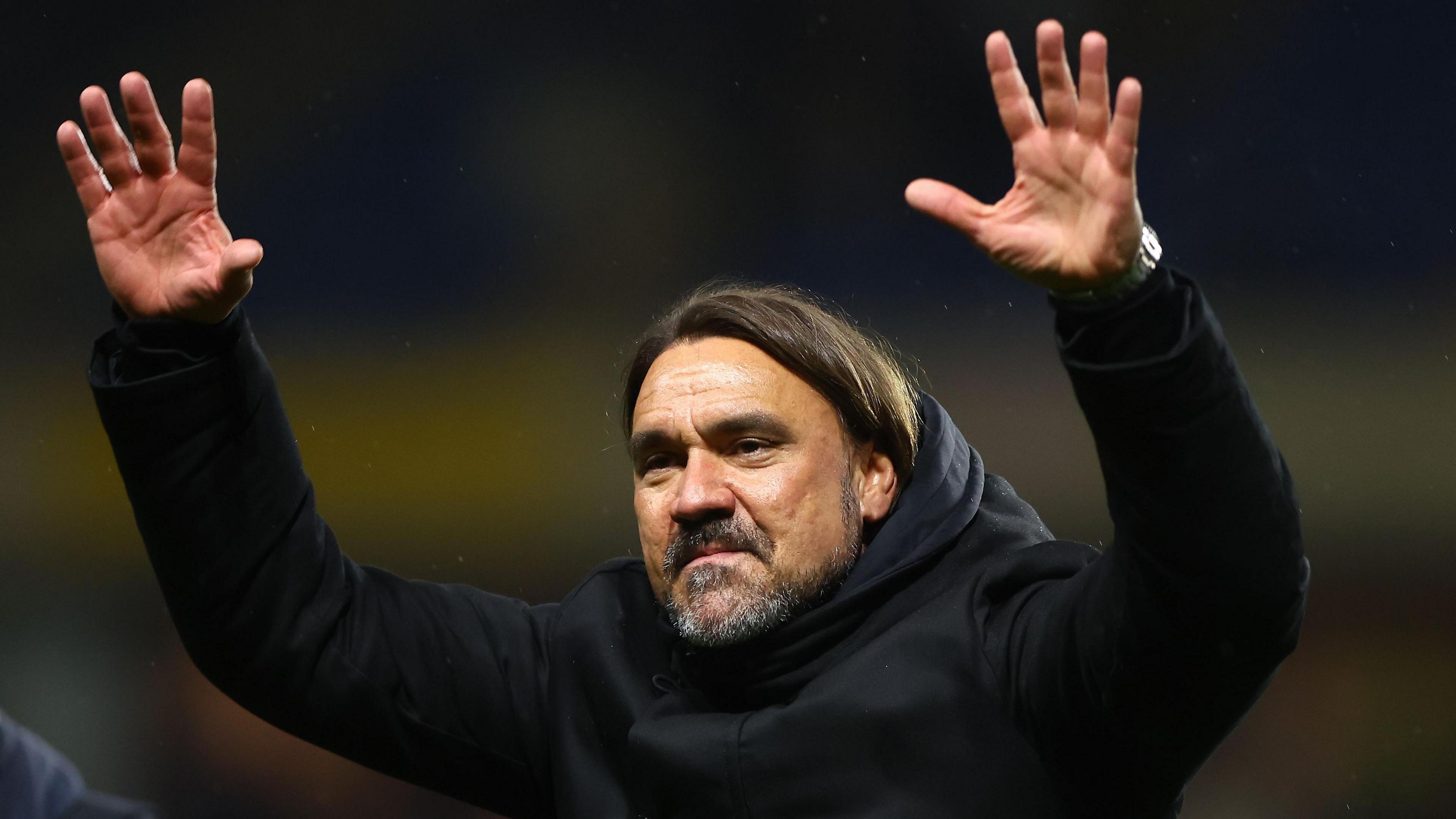 Daniel Farke with his arms raised towards the Leeds fans after the match