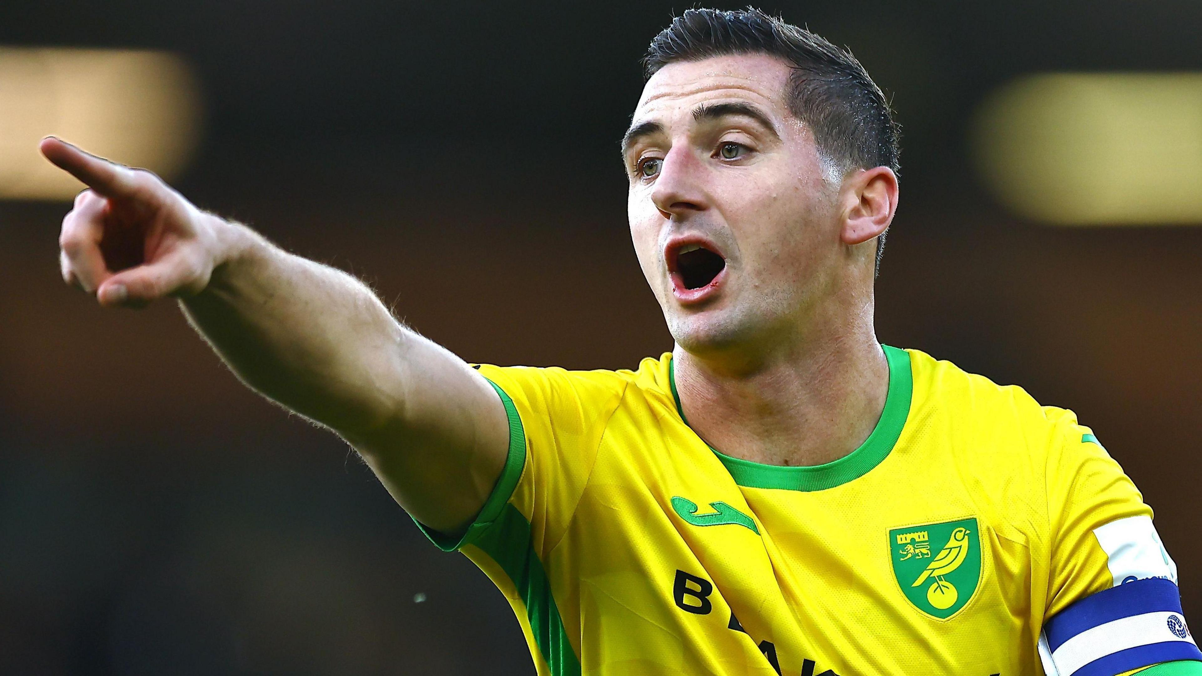 Kenny McLean points his right index finger during a game for Norwich City last season