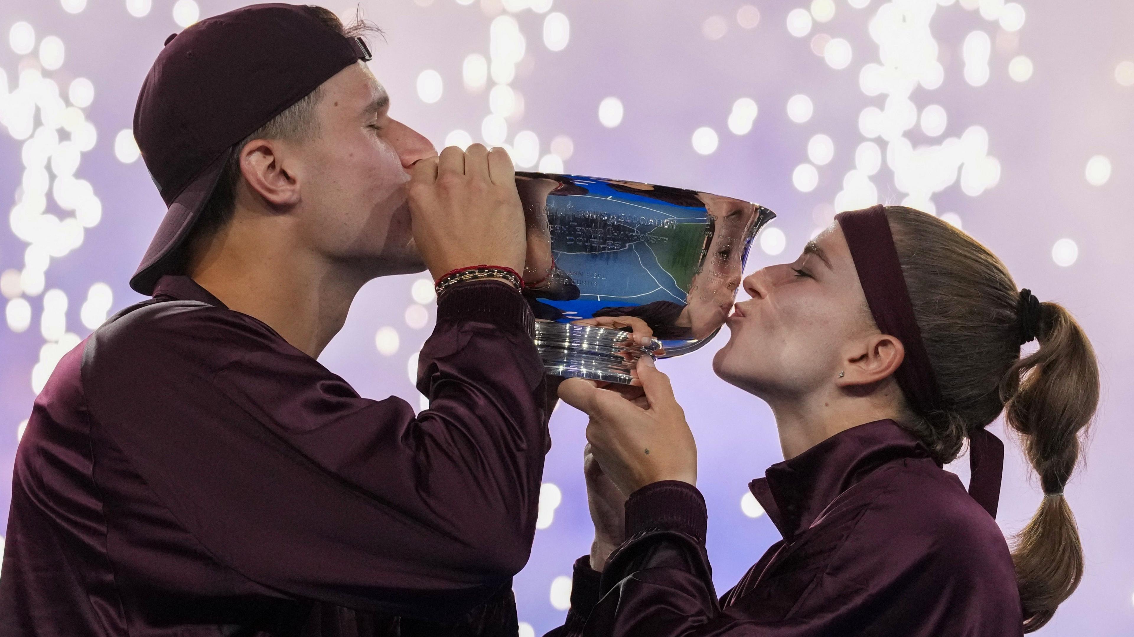 Jakub Mensik and Karolina Muchova kiss the US Open mixed doubles trophy after beating Belinda Bencic and Flavio Cobolli in the final