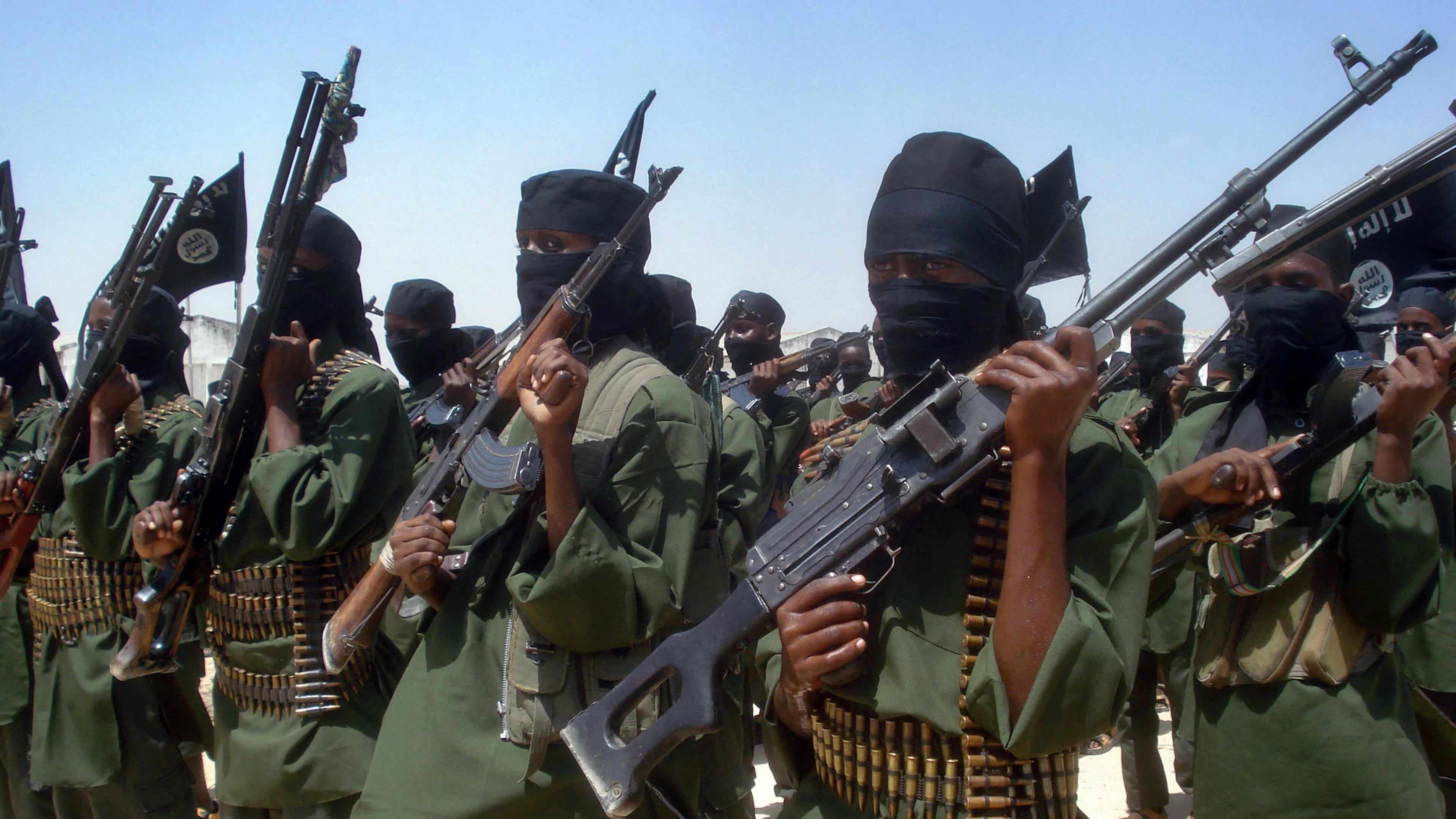 Shabab fighters in green uniform, standing in a row in a military drill