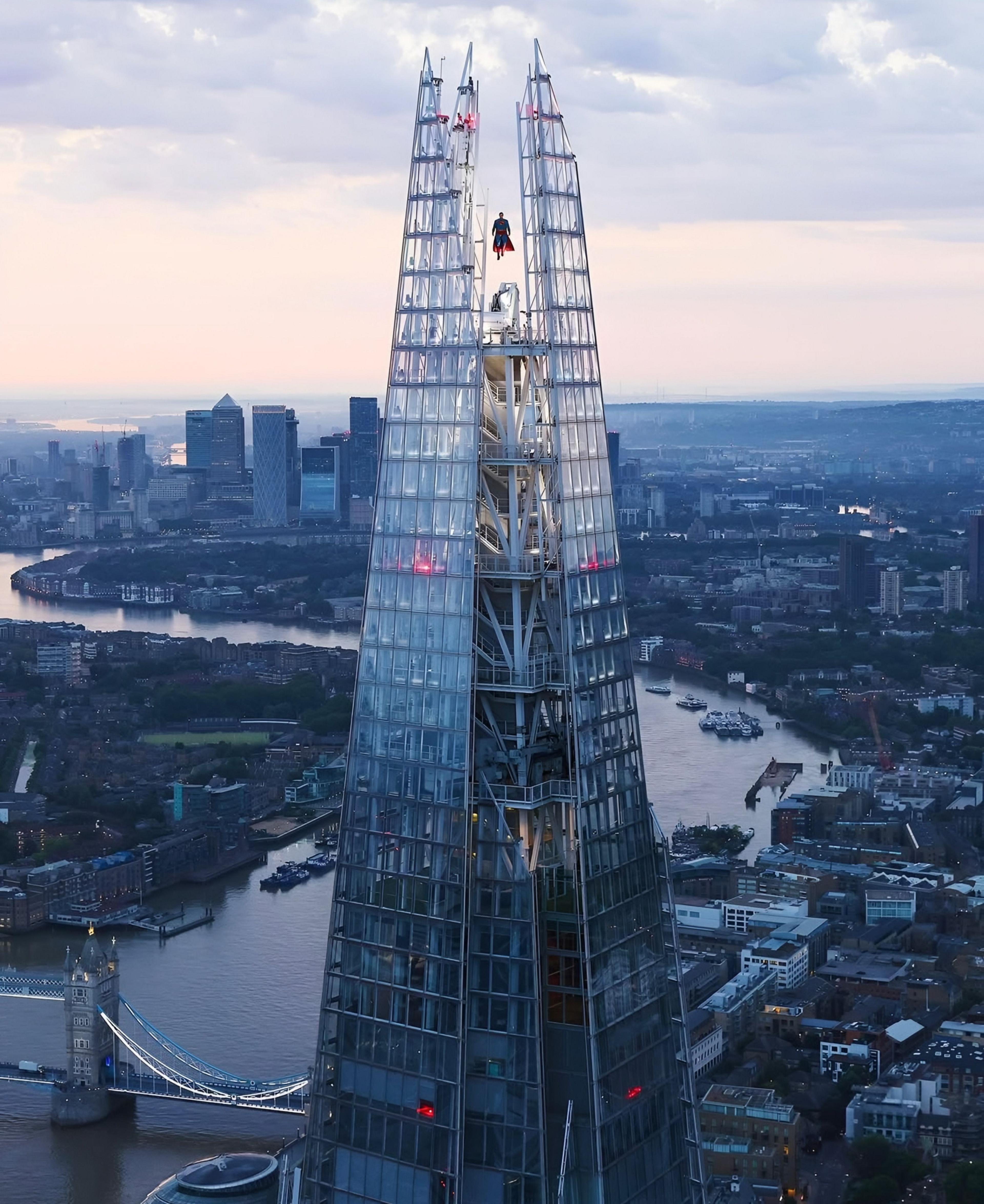 The Shard in London with a view of the skyline. You can see the small figure of Superman, that appears to be floating at the top of the skyscraper. 