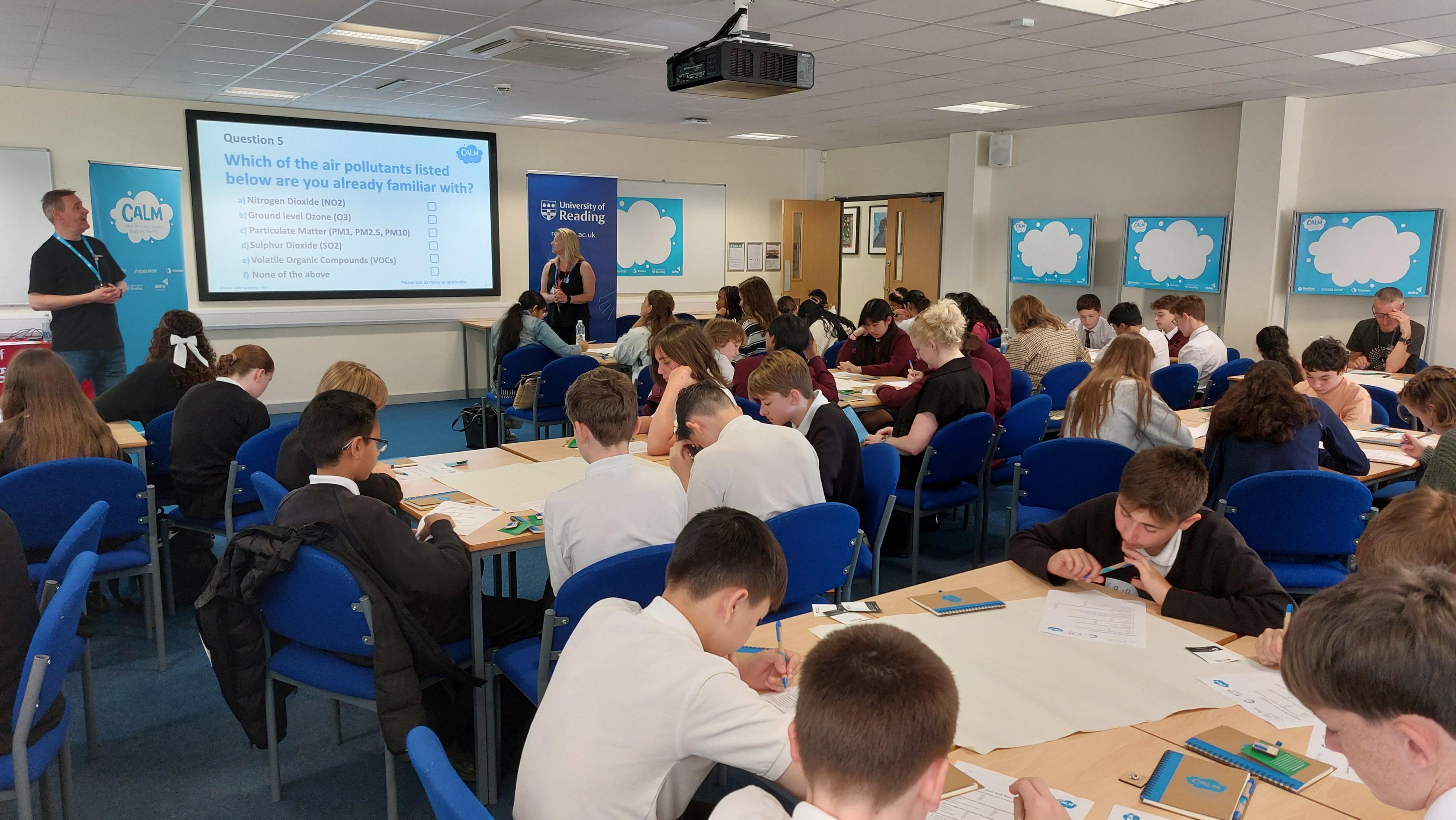 Classroom full of pupils sat at desks working together to understand the impact of air pollution.