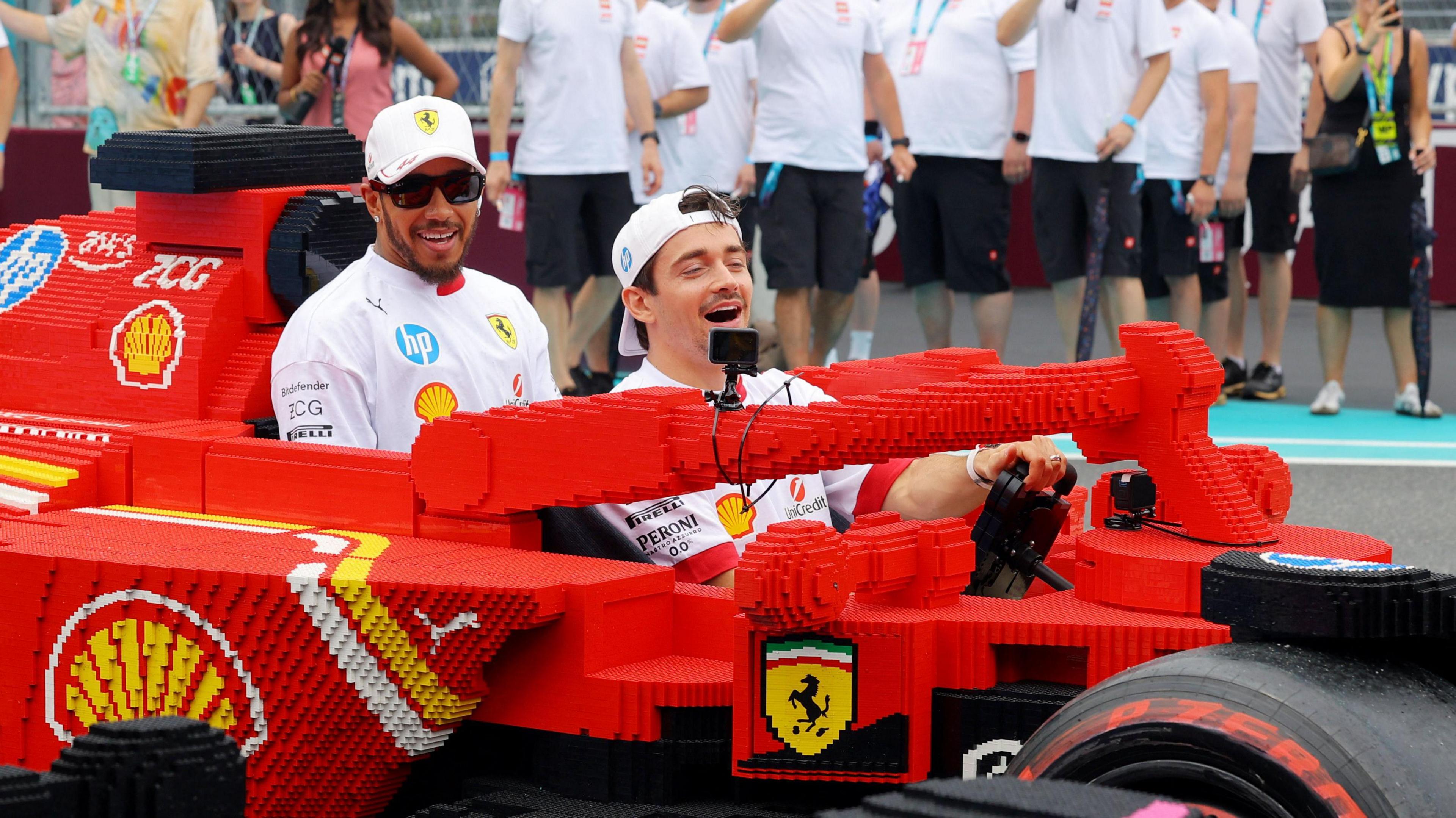 Ferrari's Charles Leclerc and Lewis Hamilton in a full sized Lego replica F1 car during the drivers parade