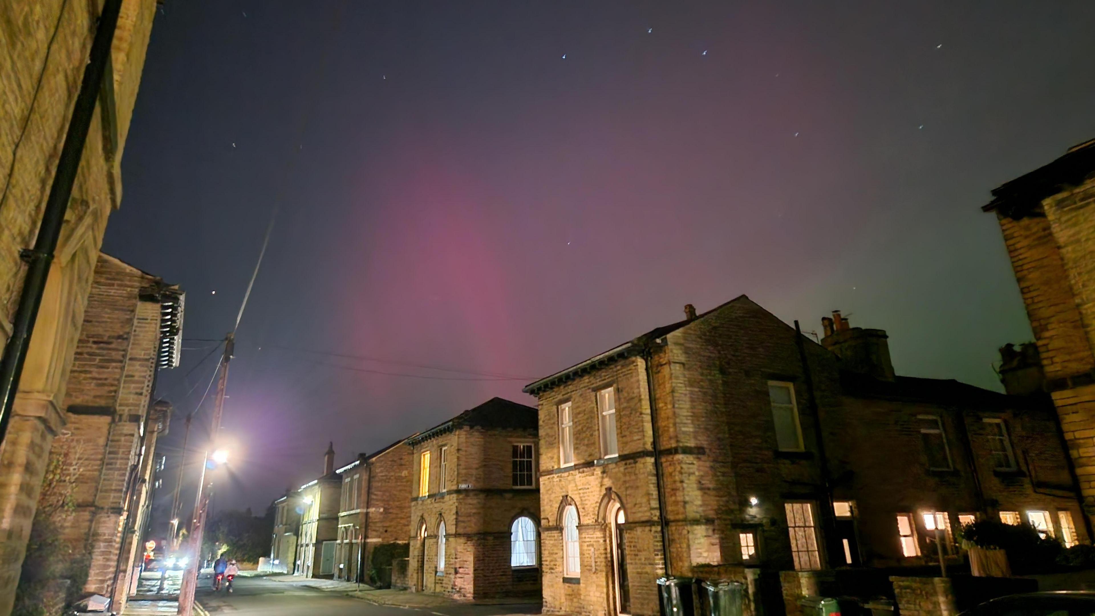 Pink skies above buildings in Saltaire