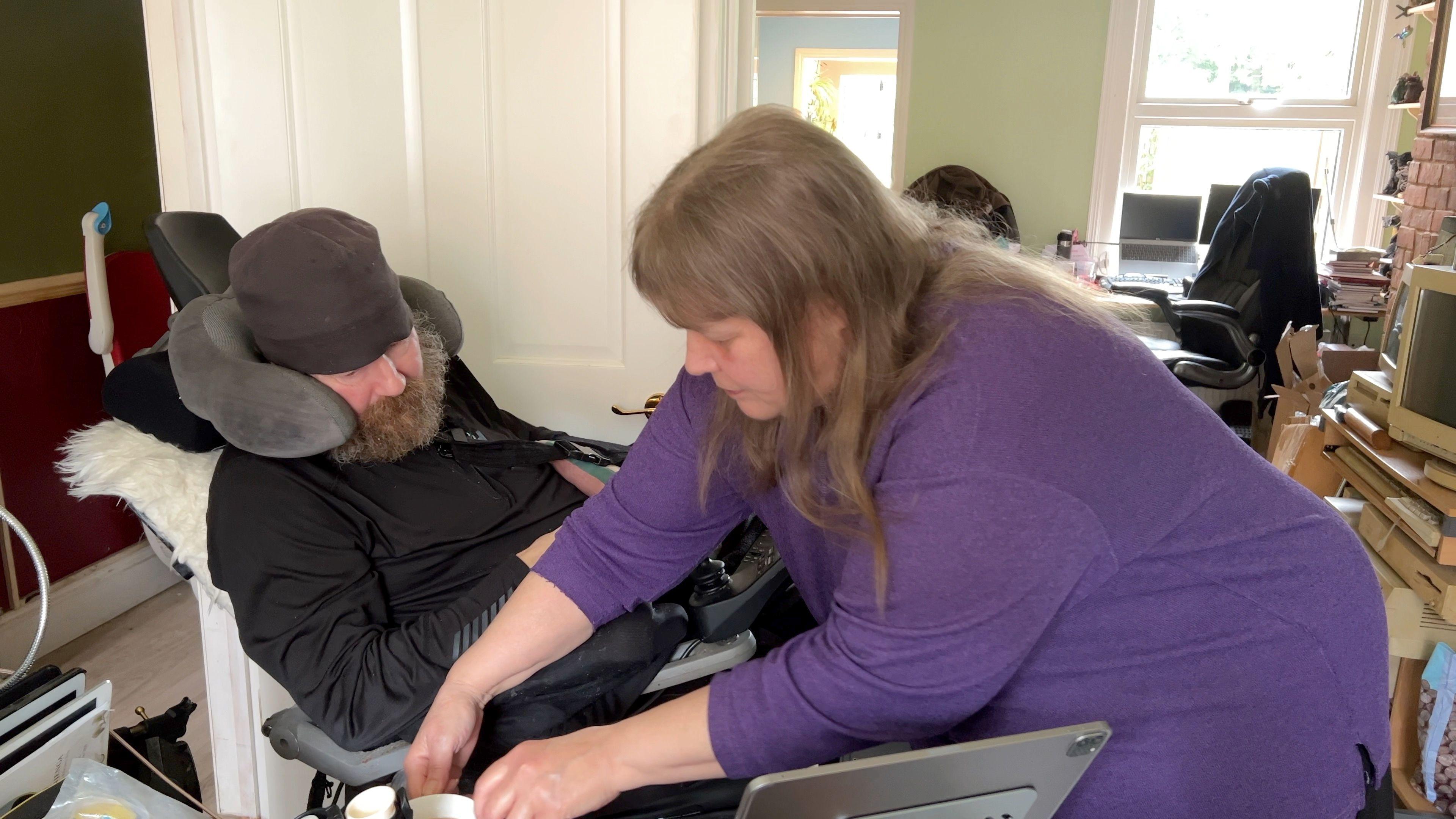 Ian Davey's partner Sherree Ball brings him a cup of coffee