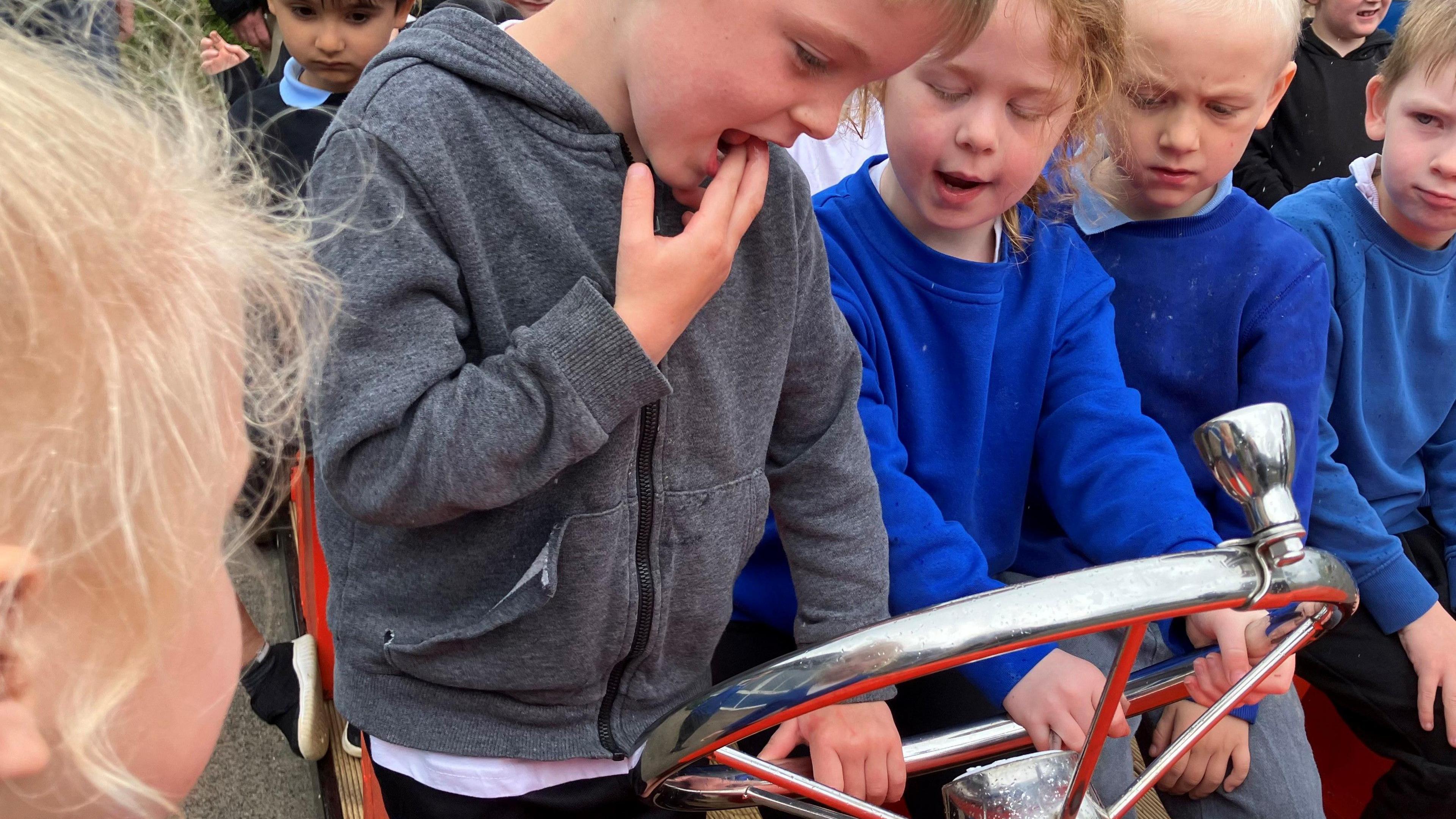 Children trying to use the steering wheel