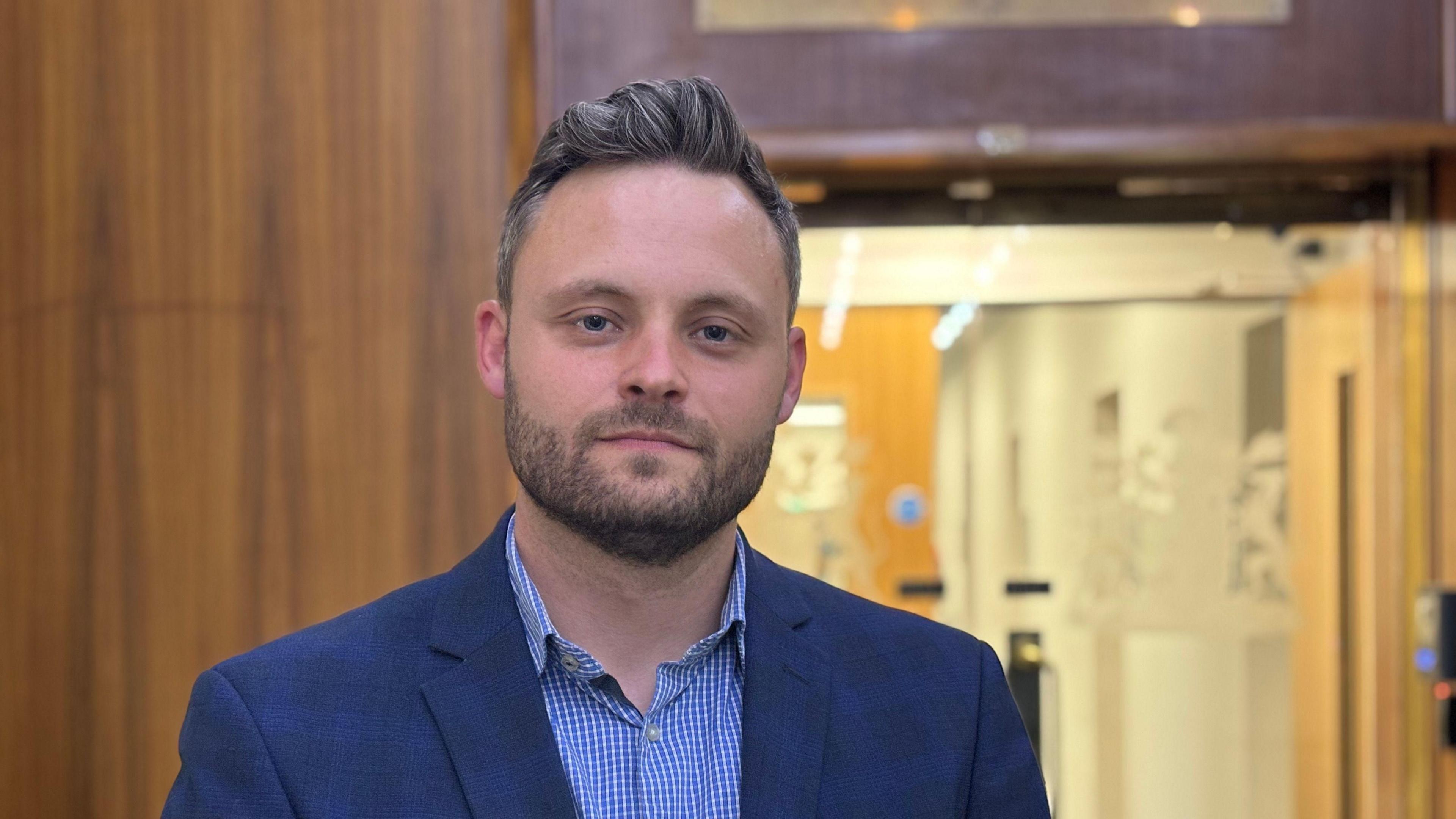 Council leader Ben Bradley in a blue checked shirt and blue jacket