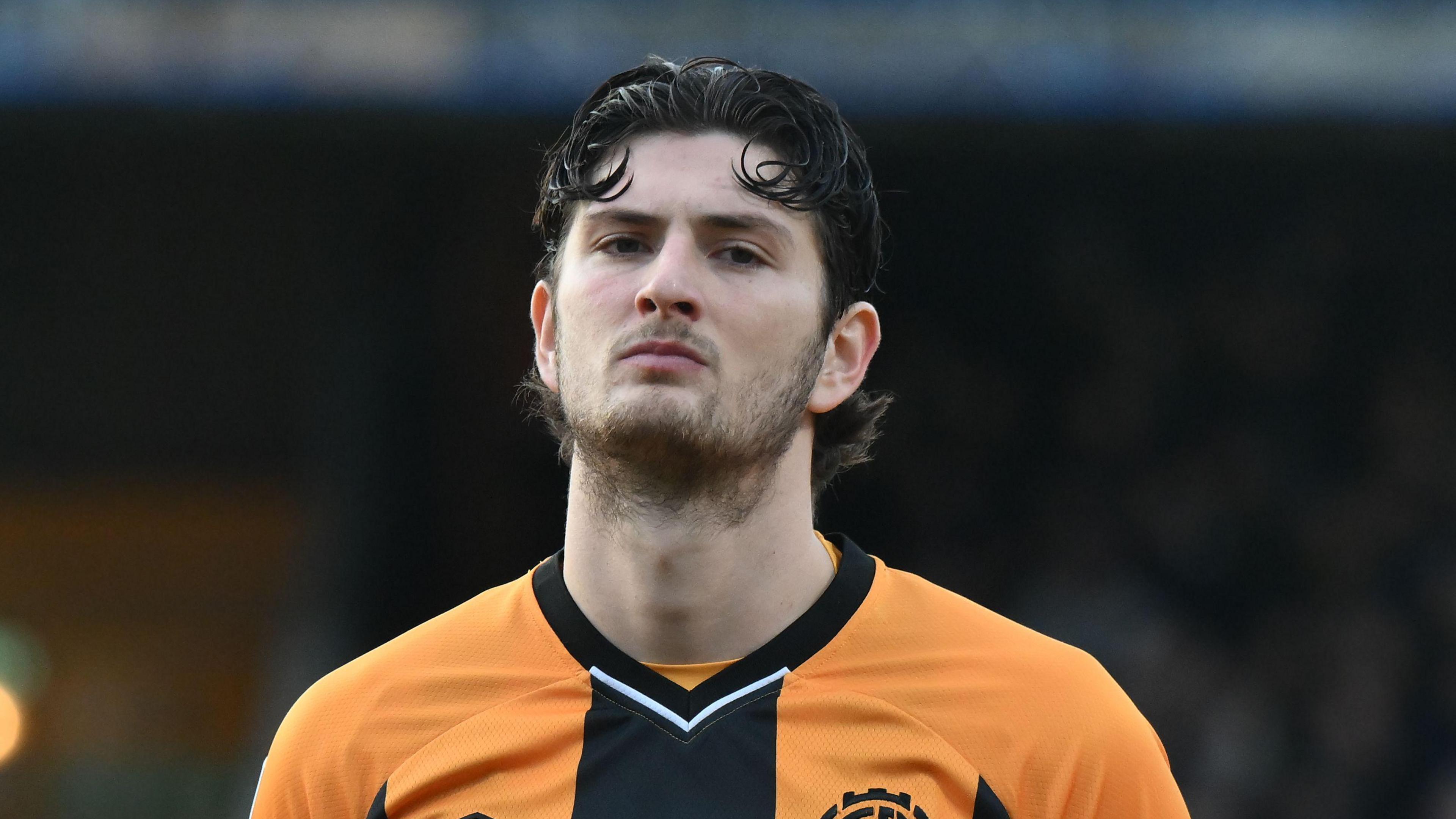 A close up of Zeno Ibsen Rossi wearing his orange and black Cambridge United kit during their game against Walsall in January