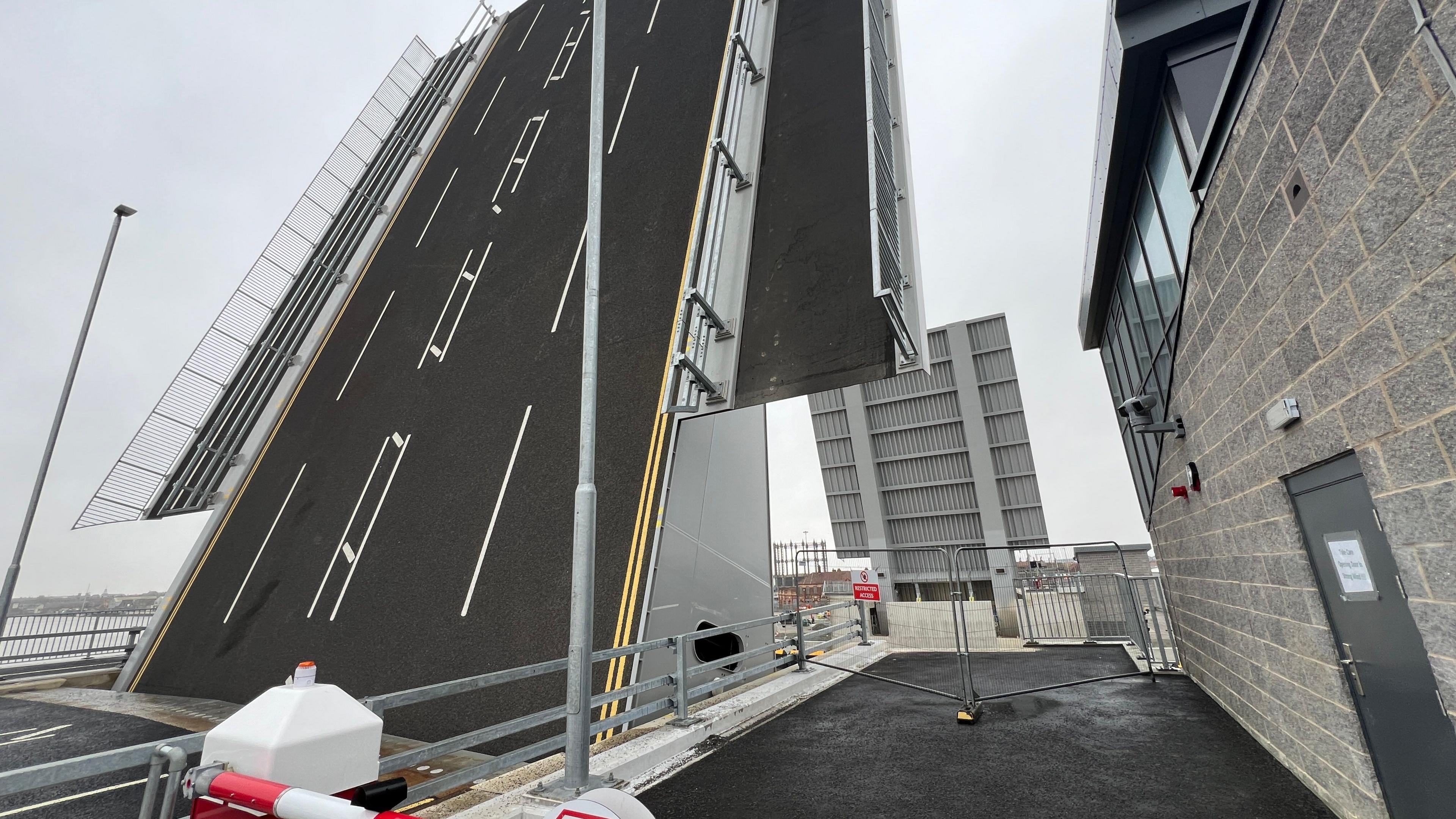 Herring Bridge in Great Yarmouth is a huge structure, with two wings that are upright to allow ships to pass. Both the road for vehicles and pedestrian pavement across the bridge are at an almost 90 degree angle.