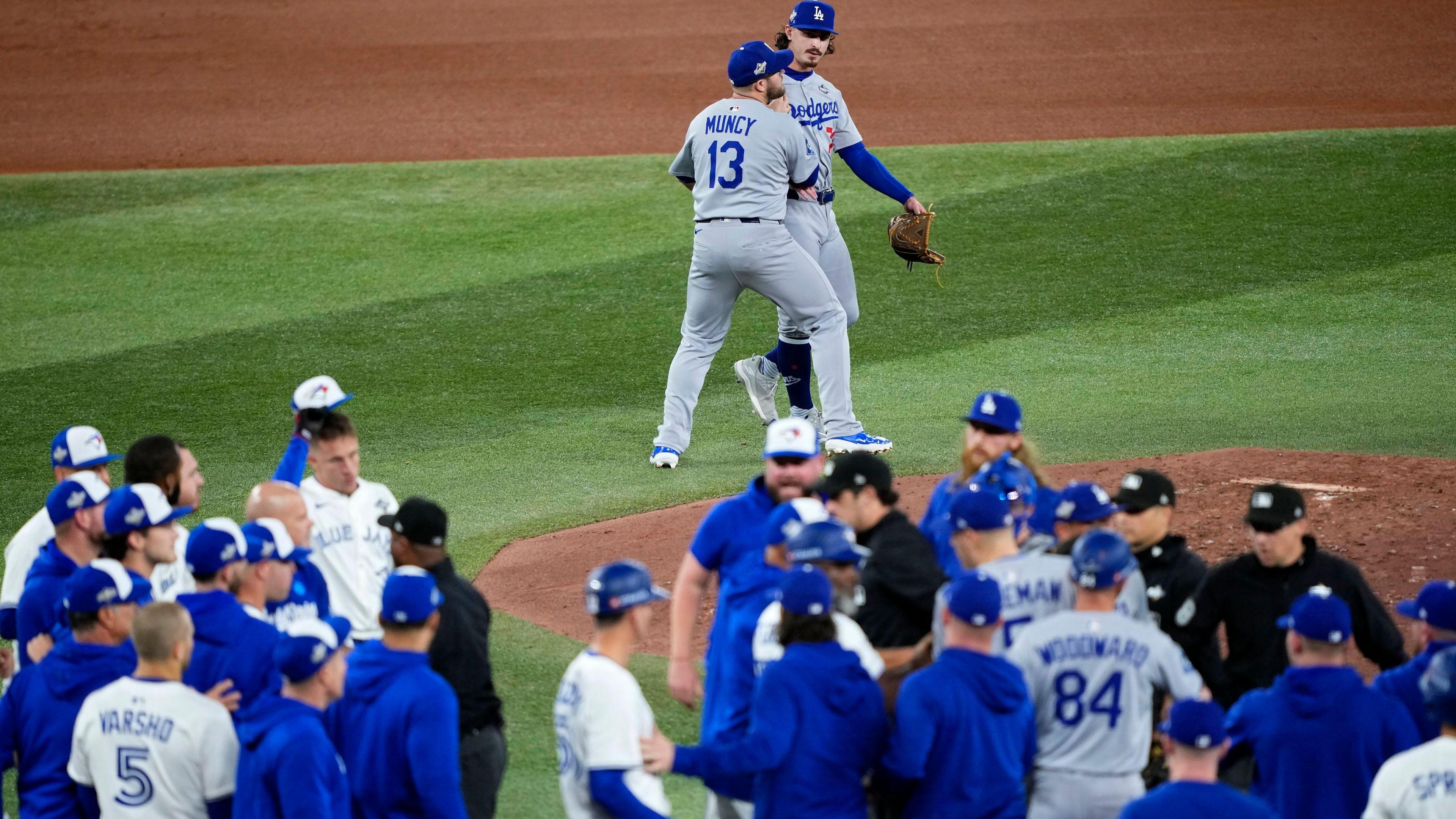 Both sets of players run on the field after Justin Wrobleski (top of picture) hit Andres Gimenez with a pitch