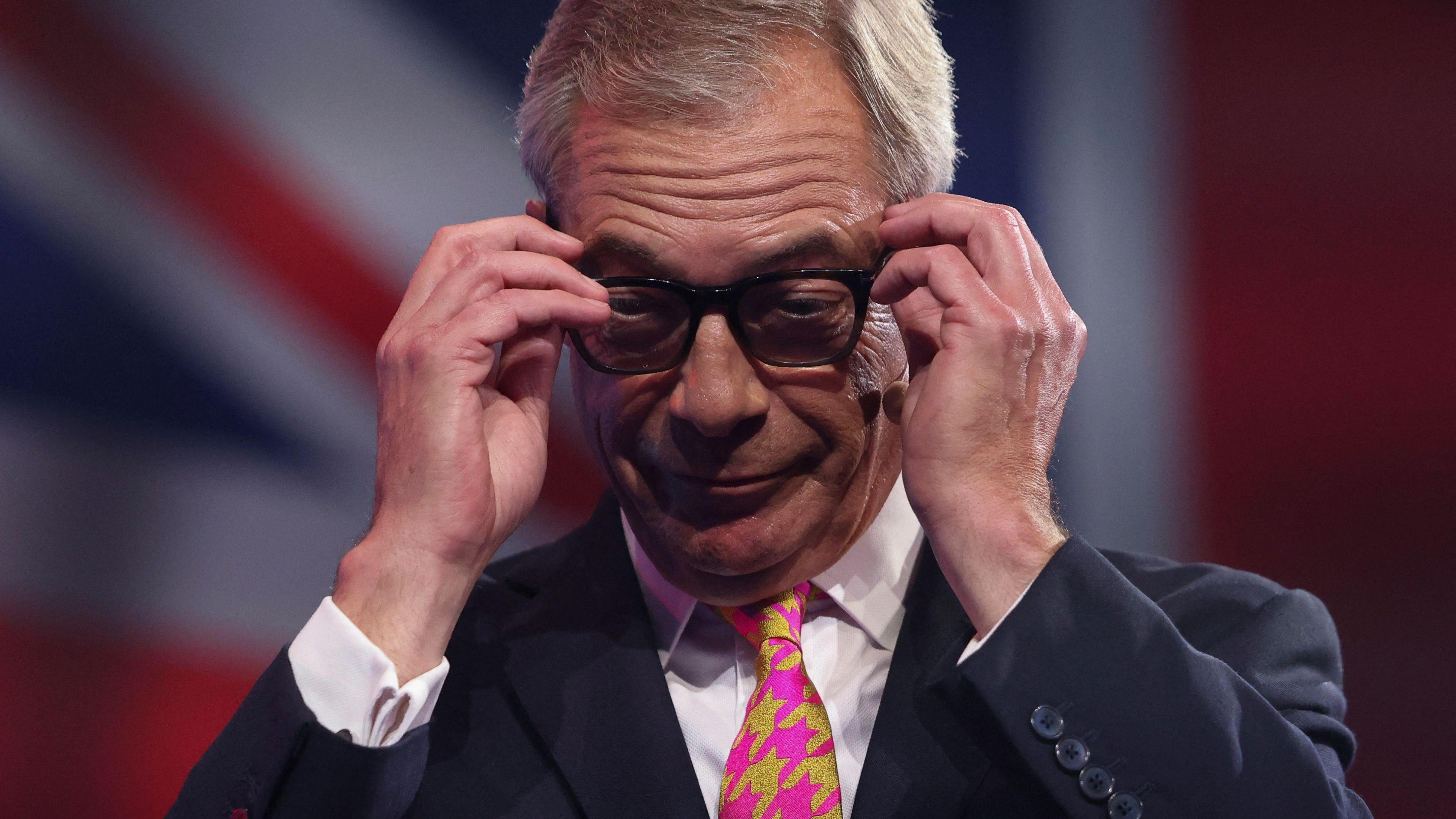 Nigel Farage wearing glasses at the Reform party conference