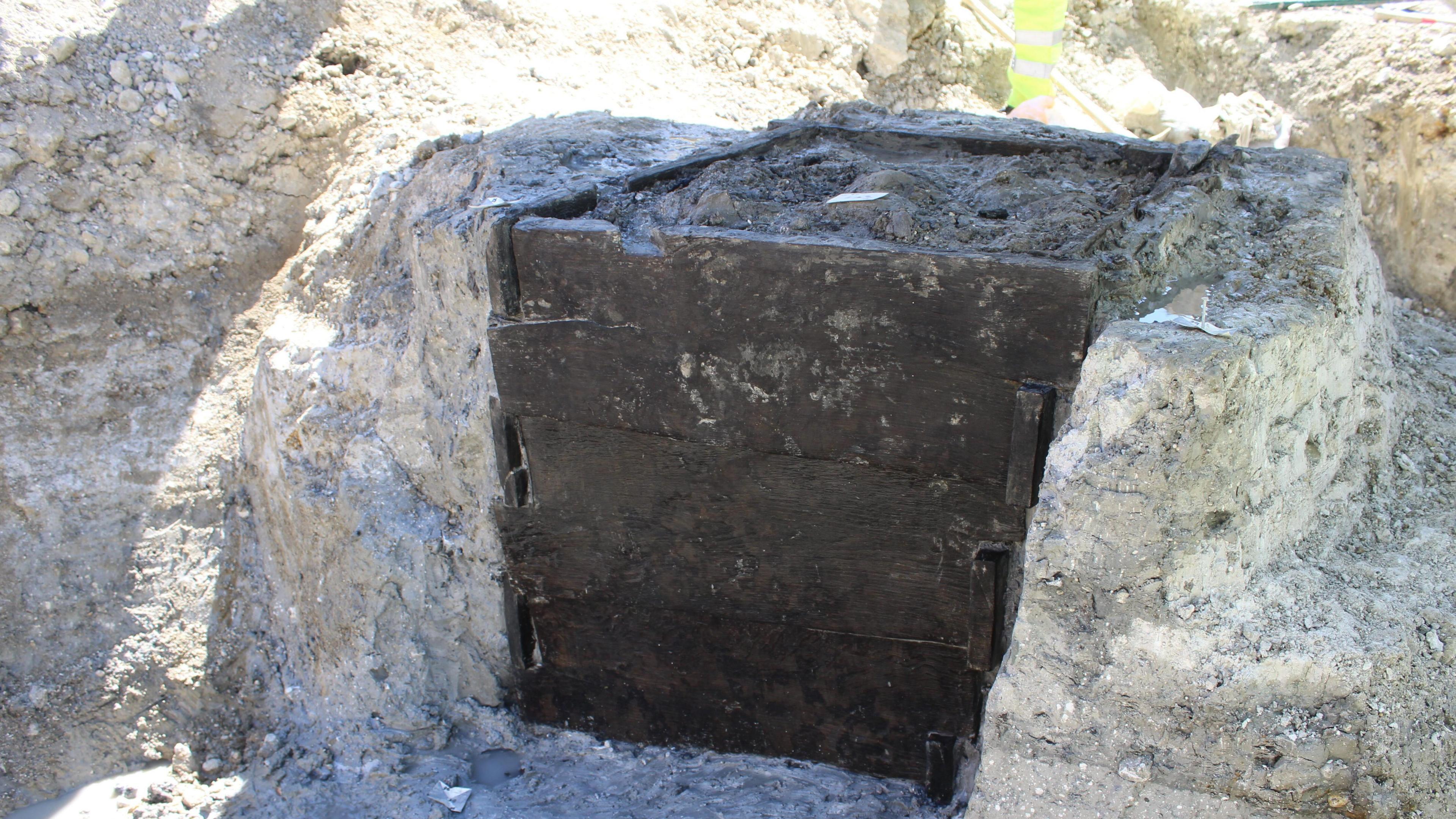 A well lined with wooden boards to support the structure and stop it caving in