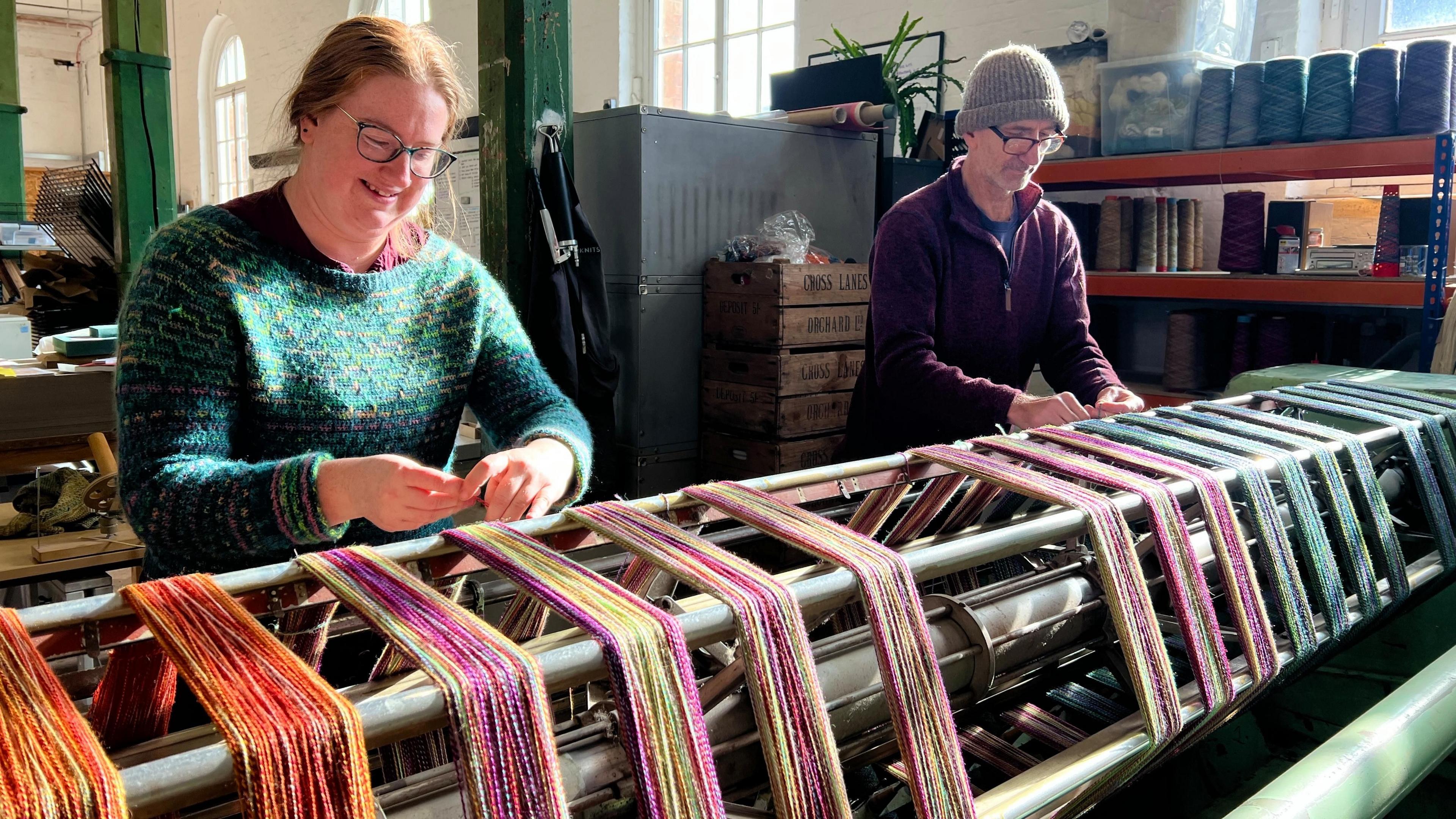 Becci and Markus using a winding machine to spin yarns uniformly into loops