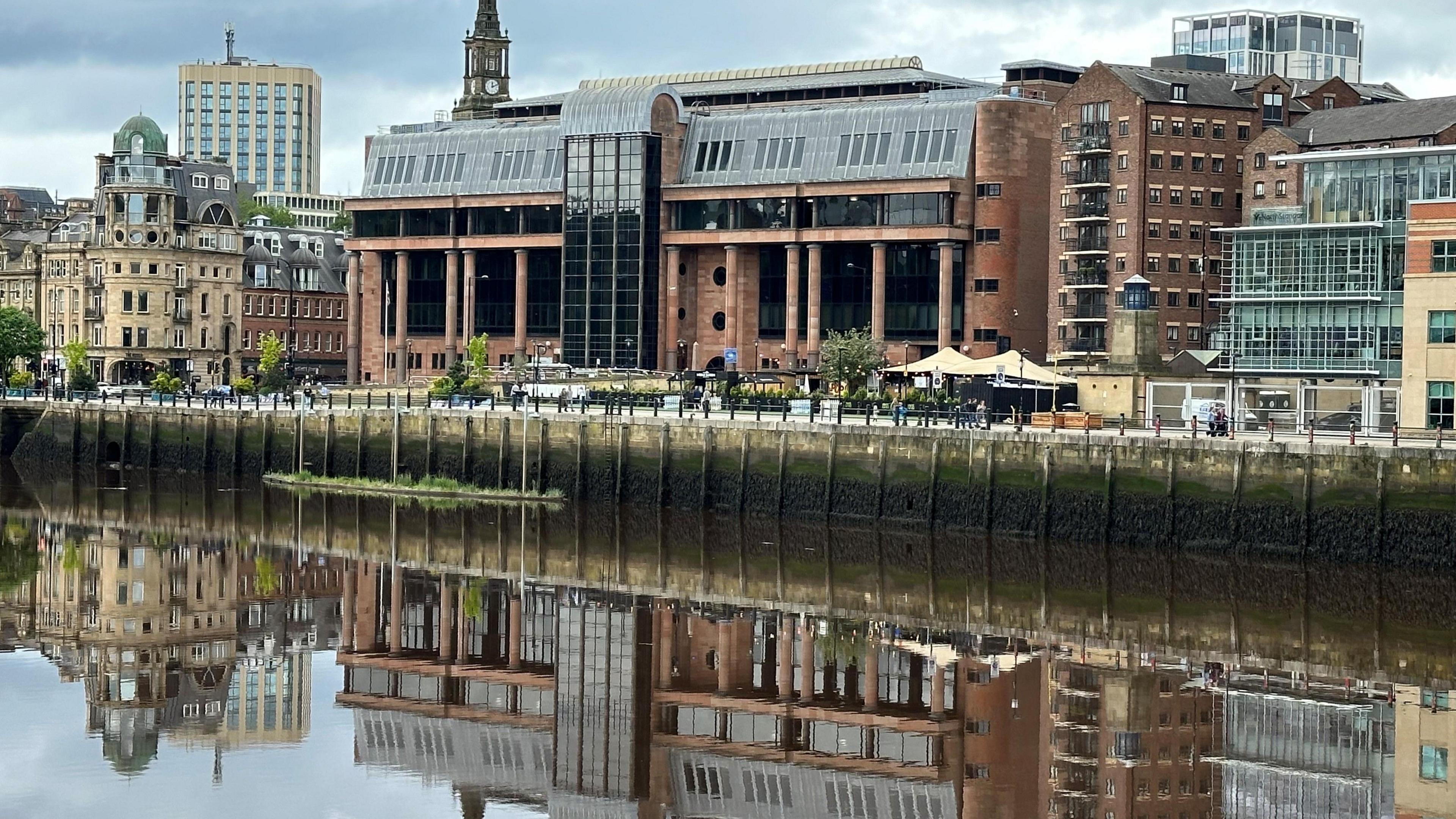 A court building reflected in a river.