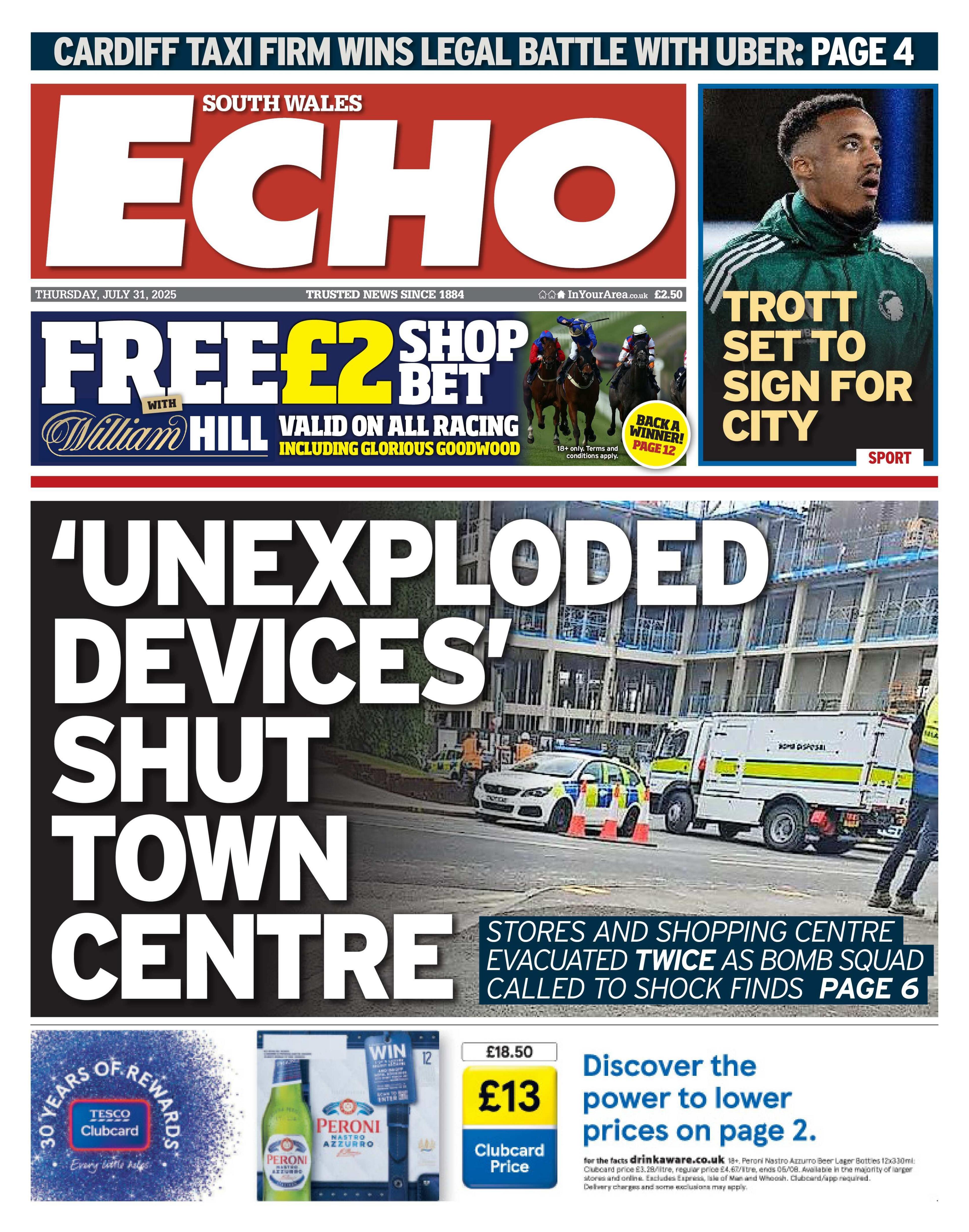 The South Wales Echo newspaper front page shows main headline next to a photo of emergency vehicles: 'Unexploded devices' shut town centre. Above is an advert for a free £2 William Hill bet and next to that is a photo of a mixed race man with the headline "Trott set to sign for City". 