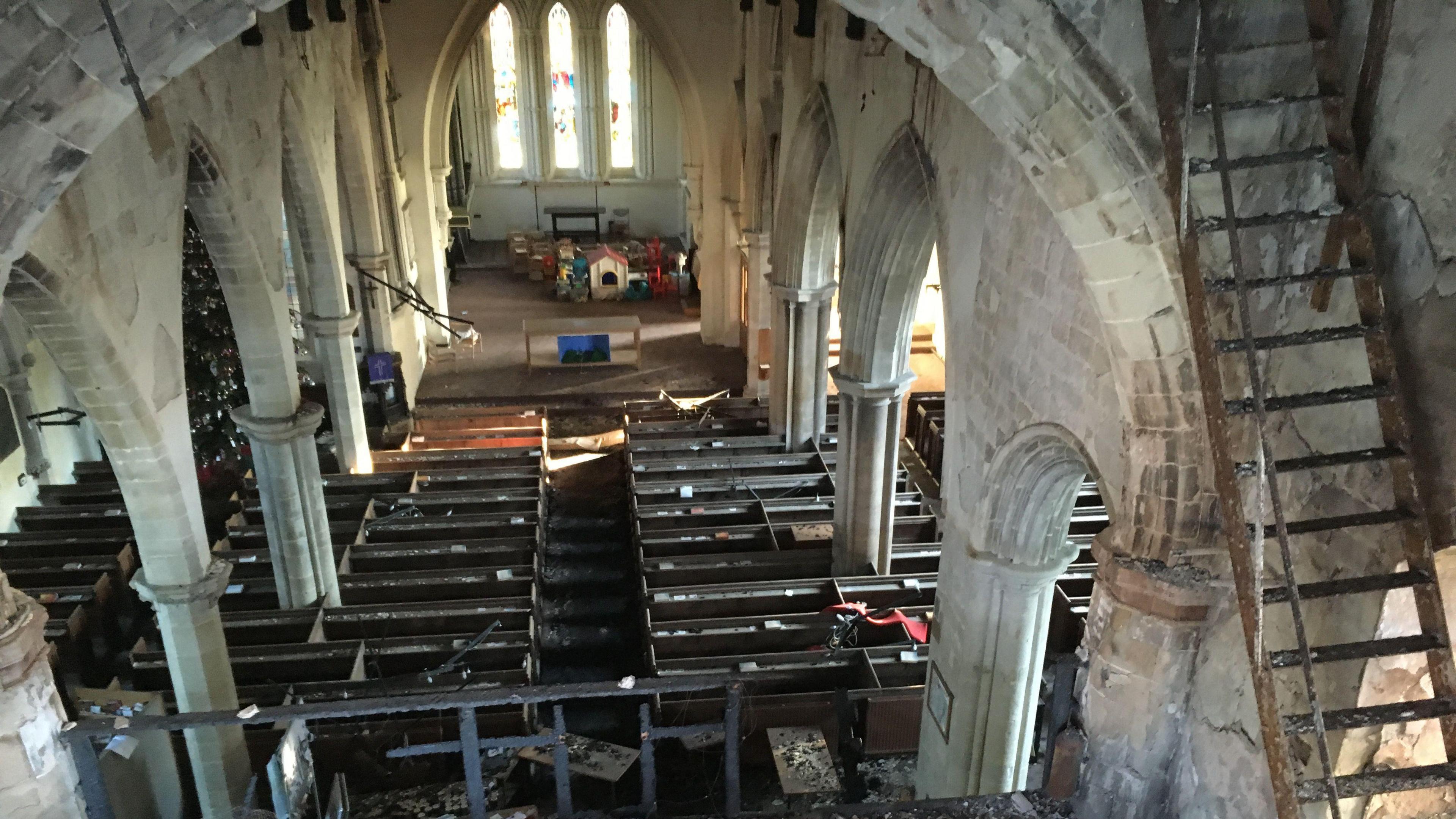 A view of the inside of the church from high above looking down on the scorched seating and alter