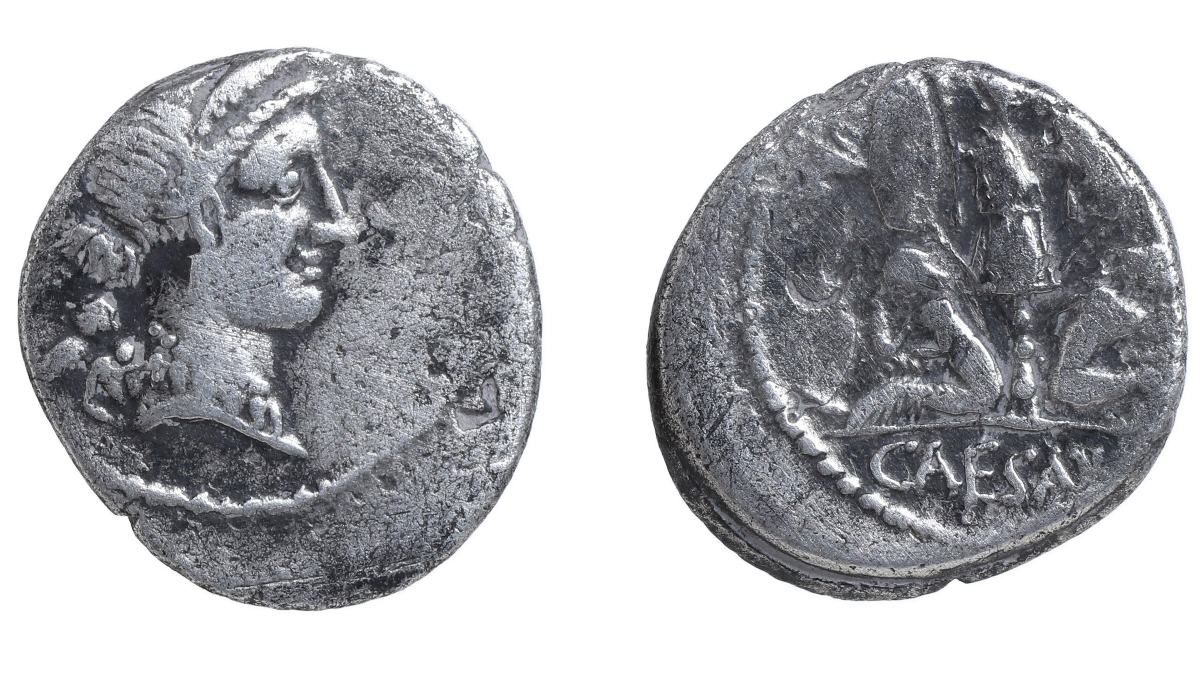 Two views of a Roman silver denarius. On the left it shows a bust of Julius Caesar. On the right is a worn design but the word Caesar can be clearly seen underneath.