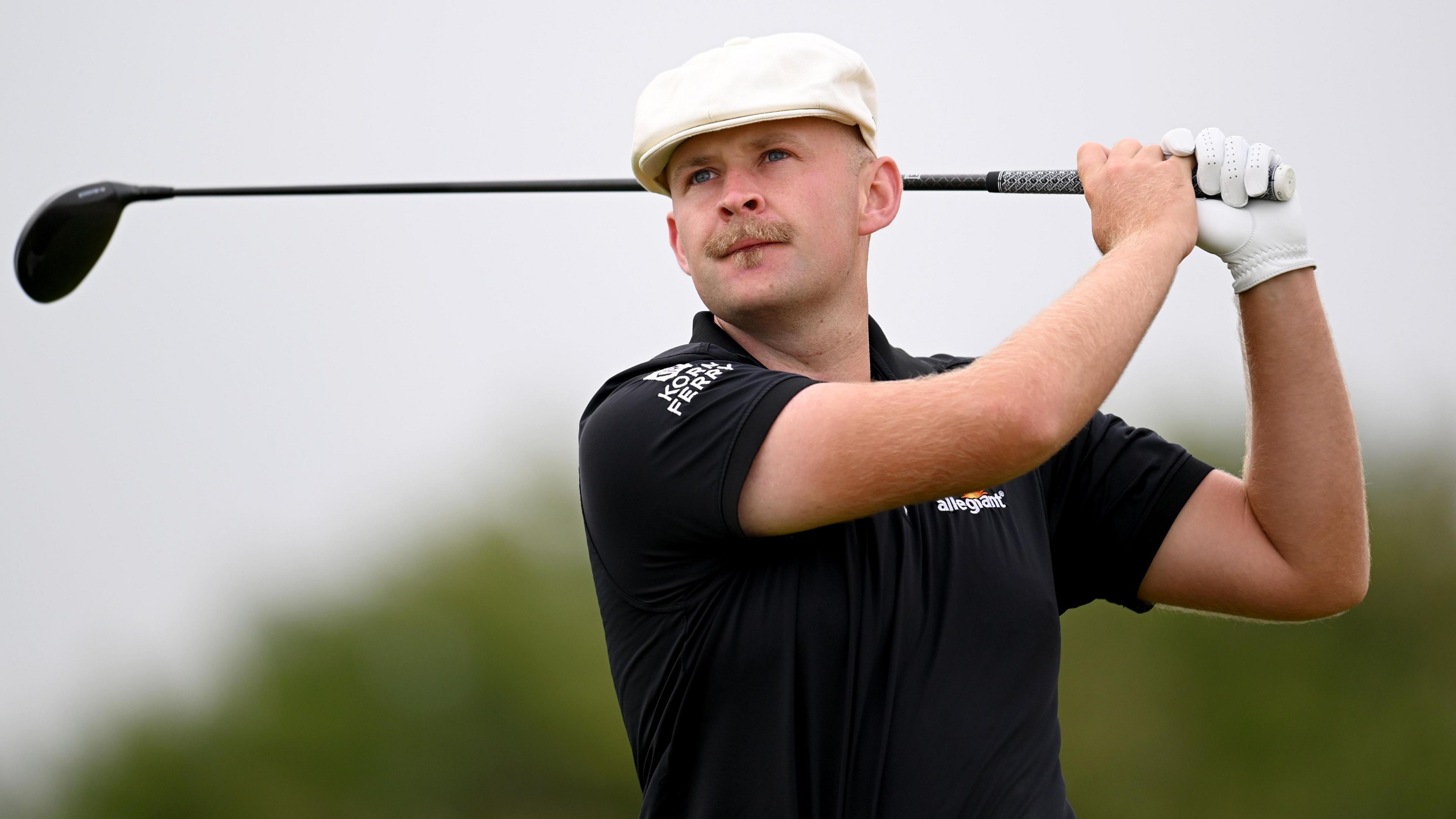 Harry Hall watches on after teeing off