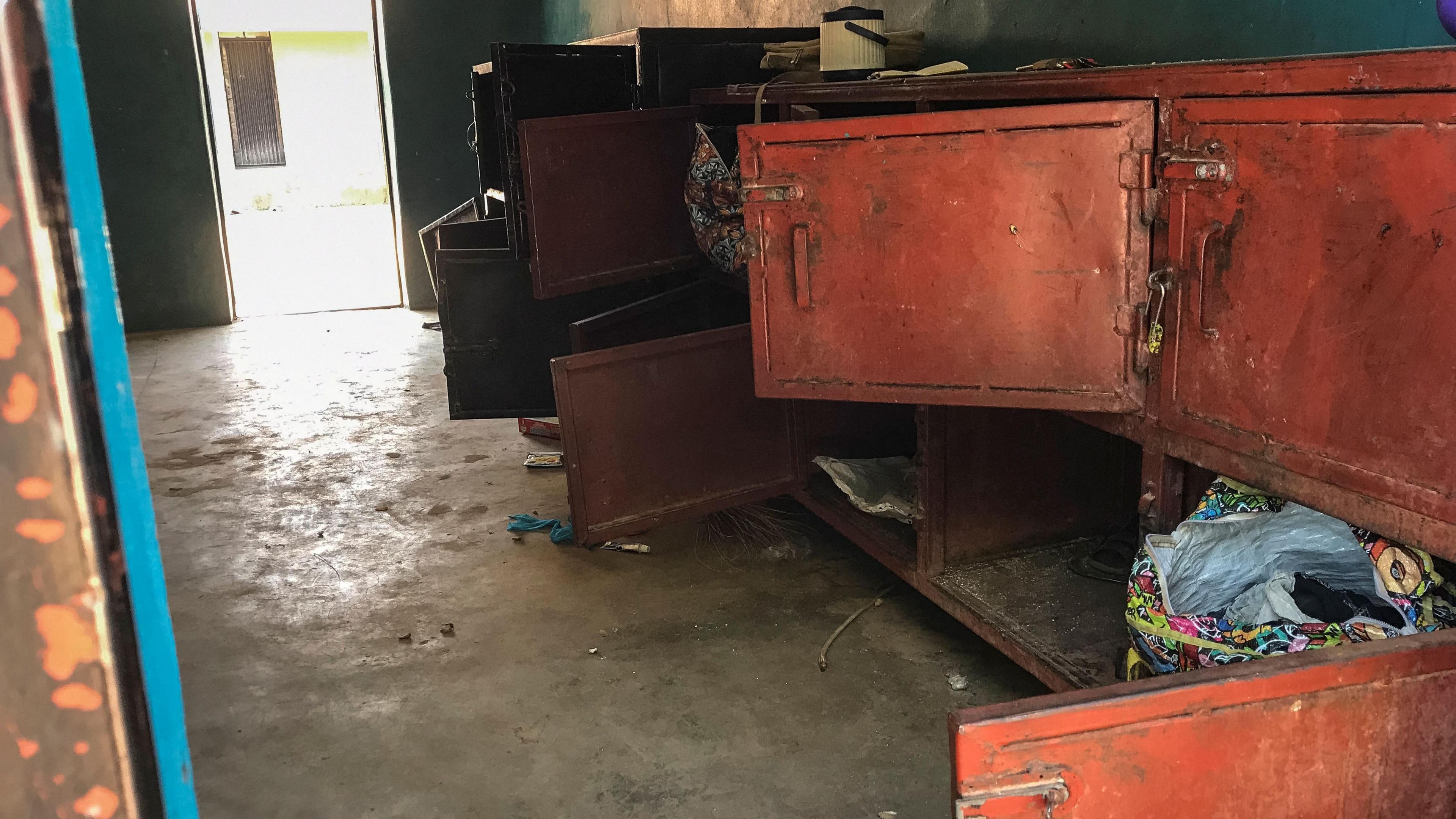 Open lockers and scattered personal belongings are seen inside a dormitory in Papiri. 