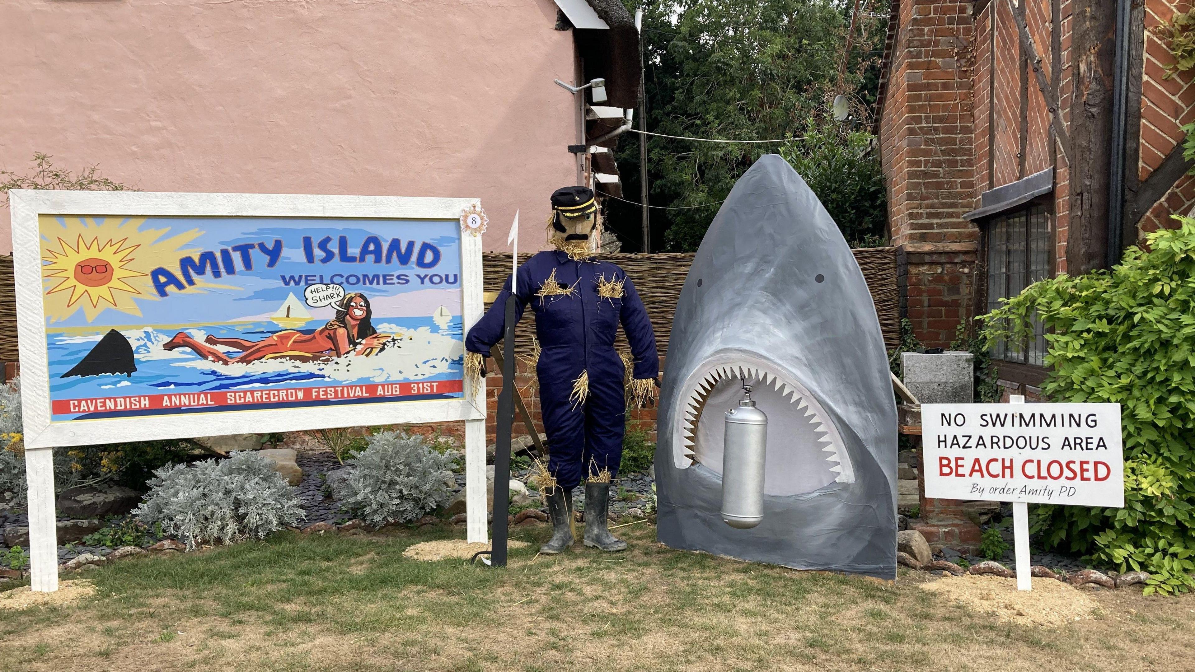 A Jaws-themed scarecrow display complete with the shark itself