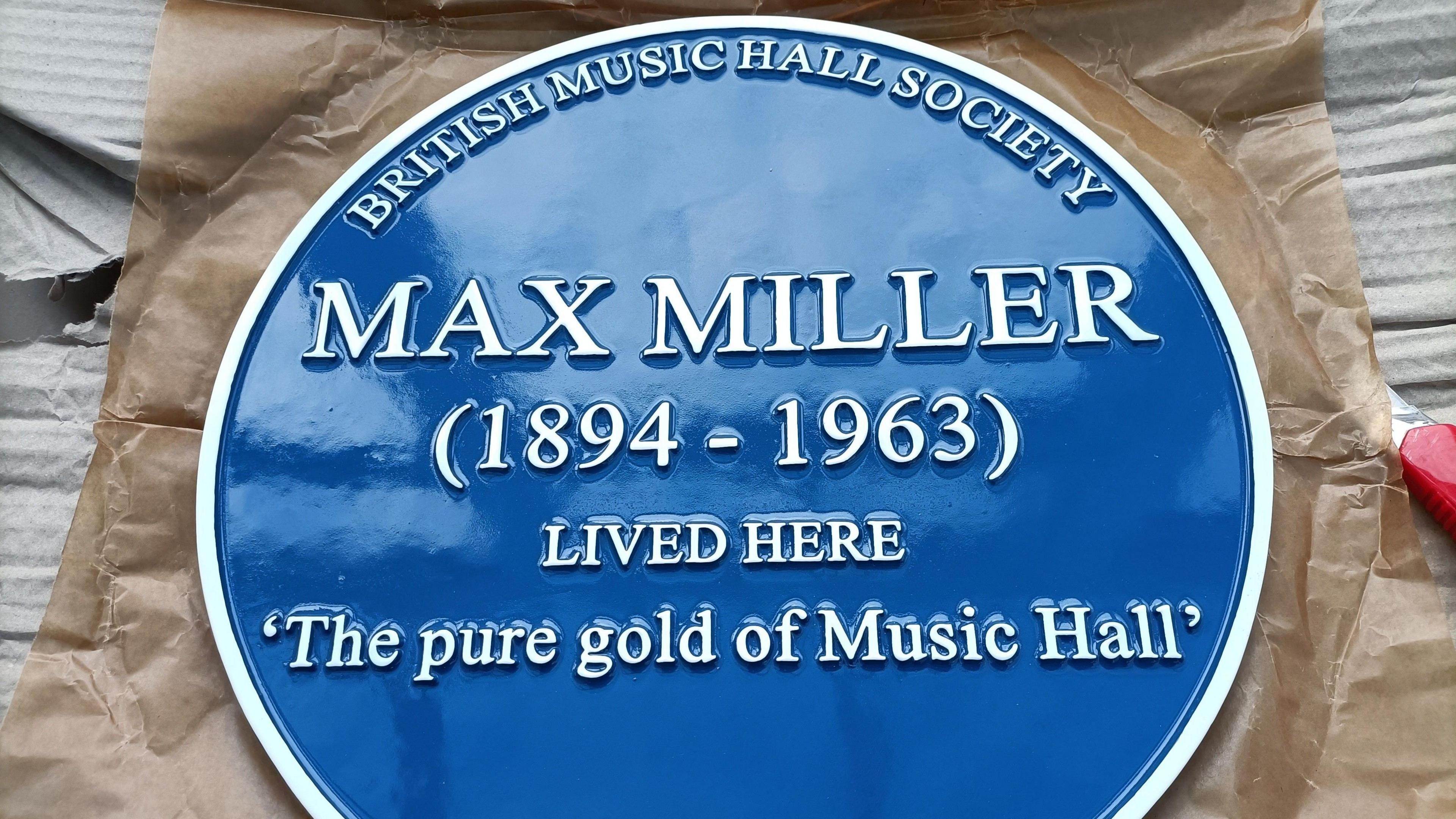 A blue plaque with the inscription: Max Miller (1894-1963) lived here. 'The pure gold of Music Hall'