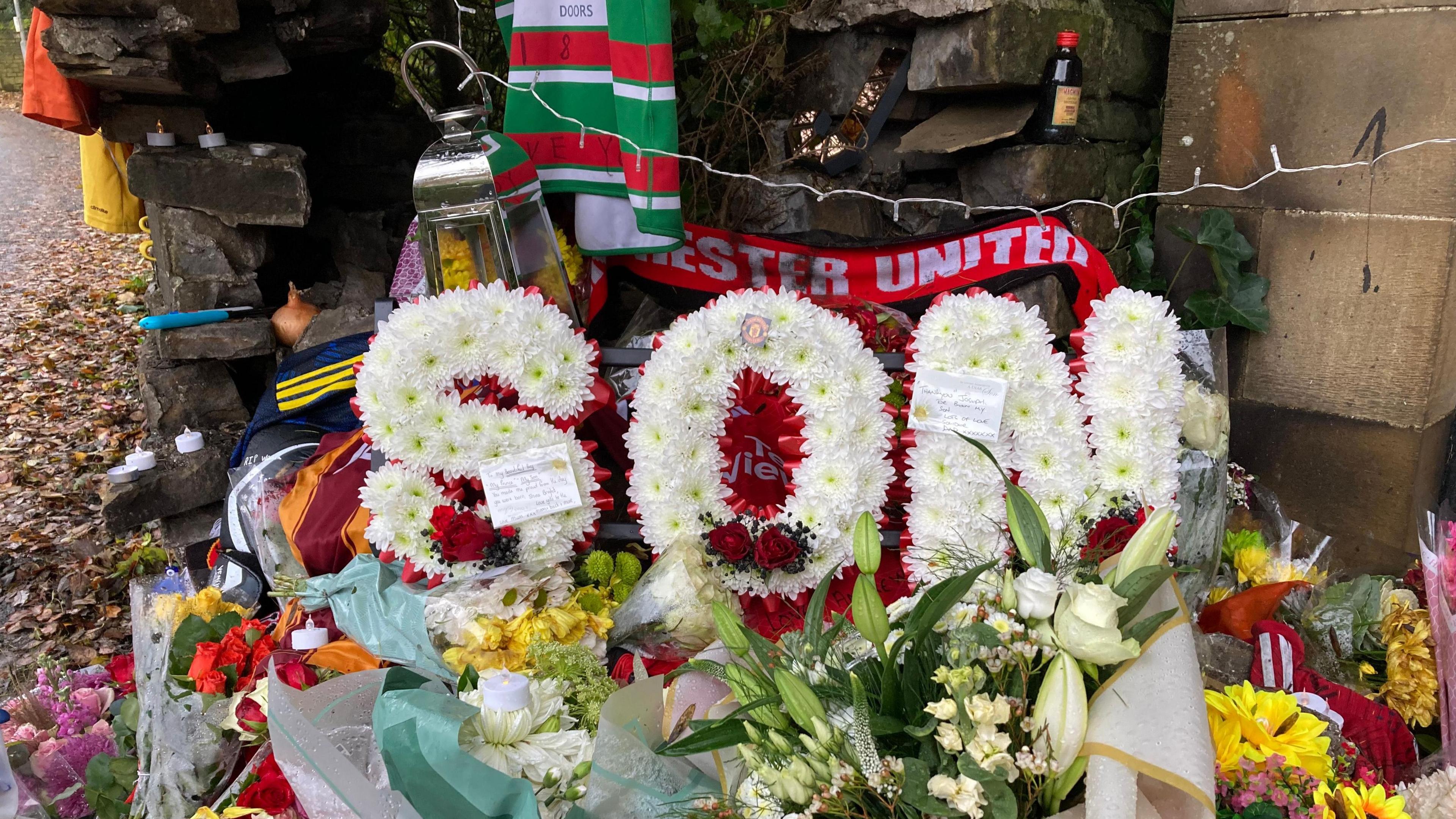 Floral tributes spelling son