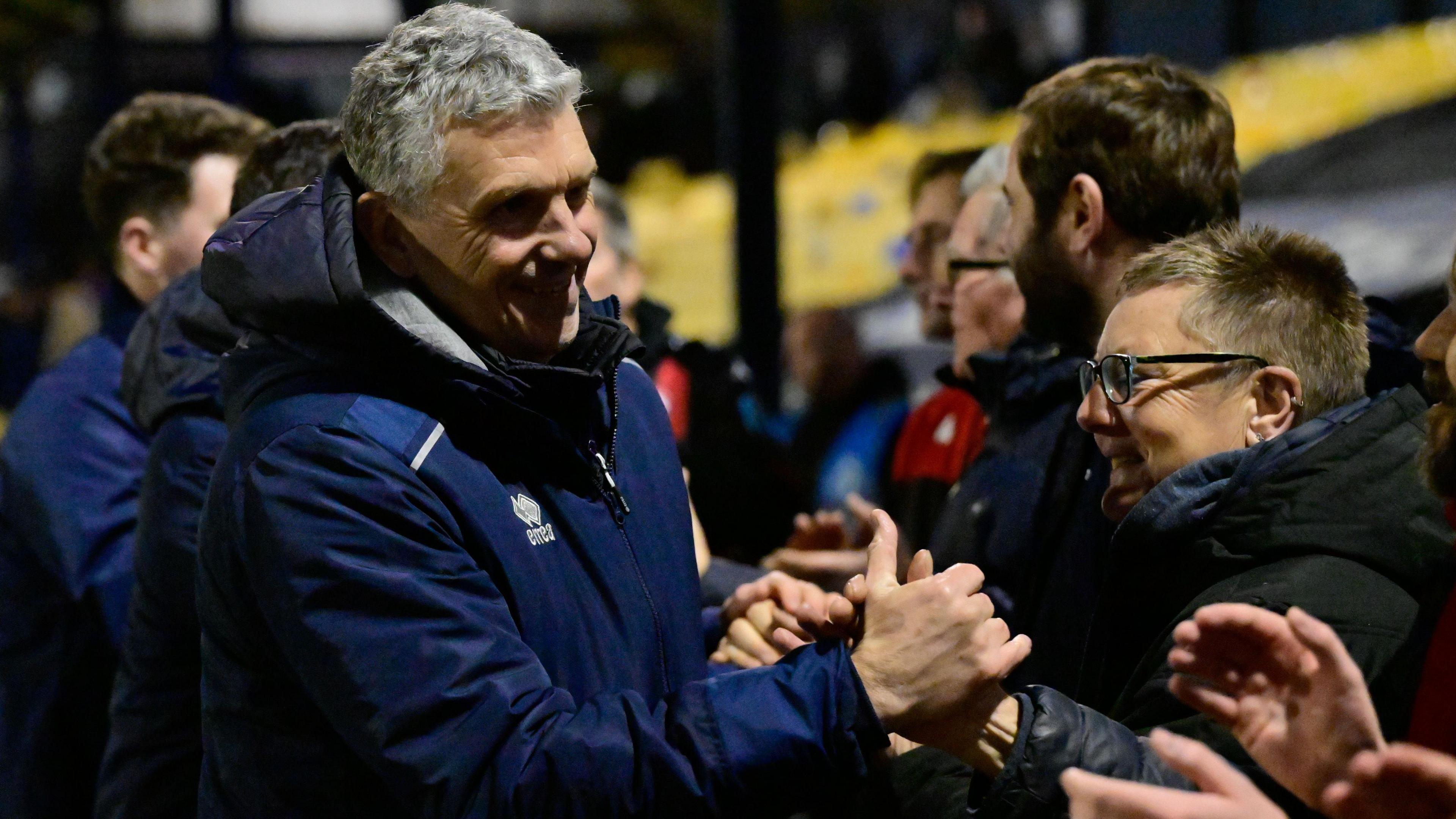 John Askey shakes the hands of Truro fans
