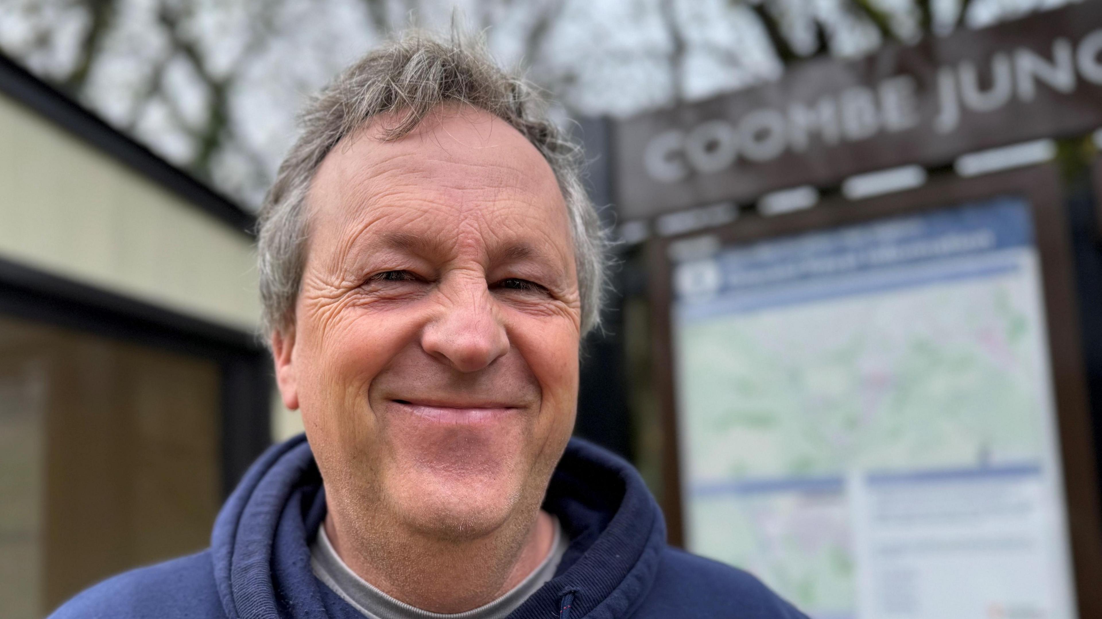 Man with grey hair standing on Coombe Junction Halt station 