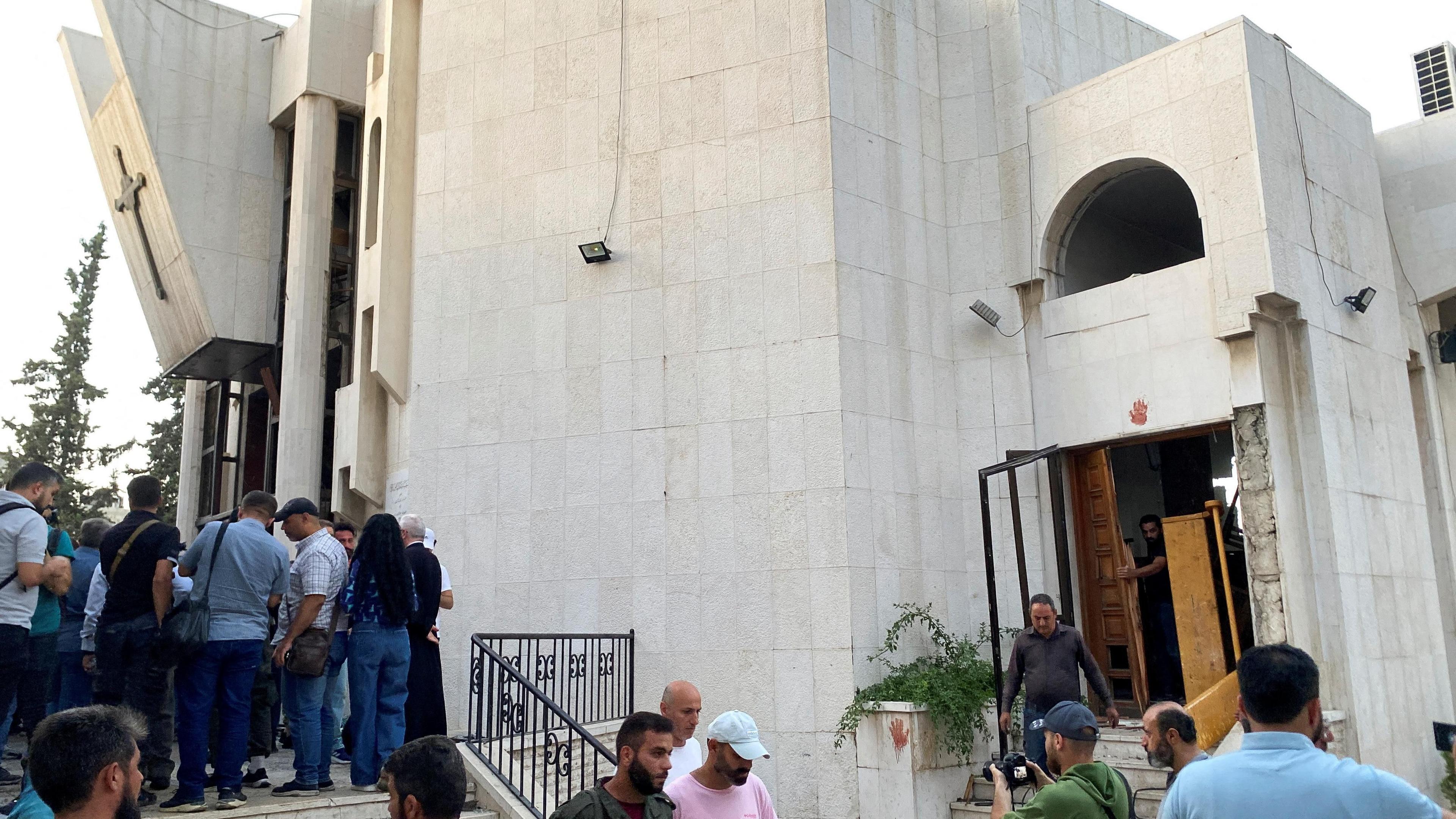 People inspect damage following a suicide bomb attack at the Mar Elias Church in Dweila, a suburb of Damascus, Syria (22 June 2025)