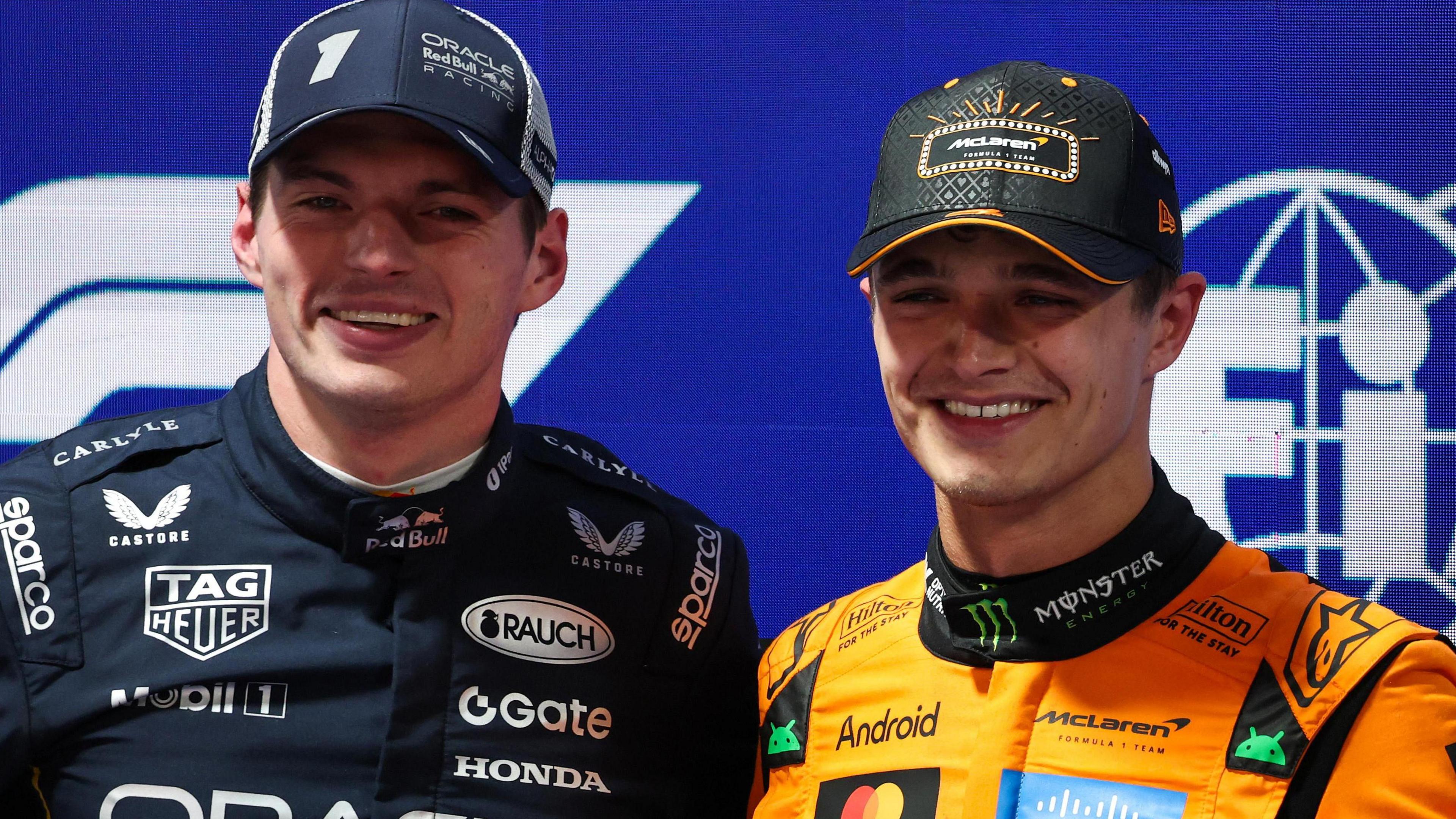 Lando Norris and Max Verstappen smile and acknowledge the crowd after qualifying for the Las Vegas Grand Prix