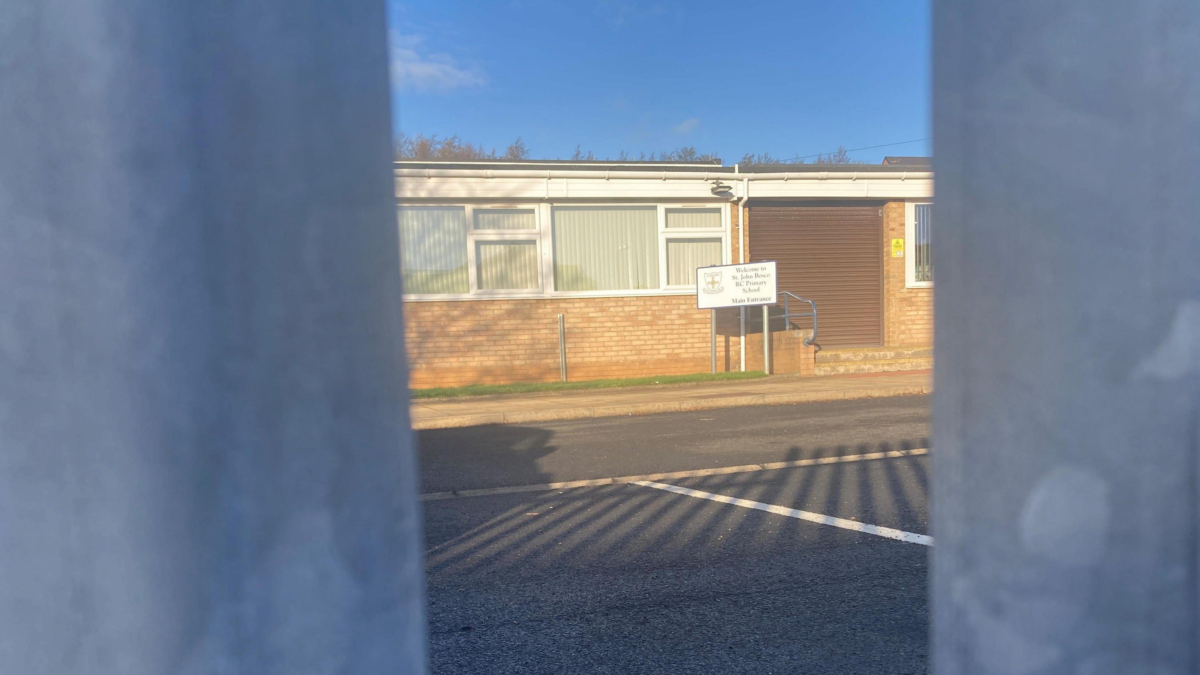 External view of school seen through railings