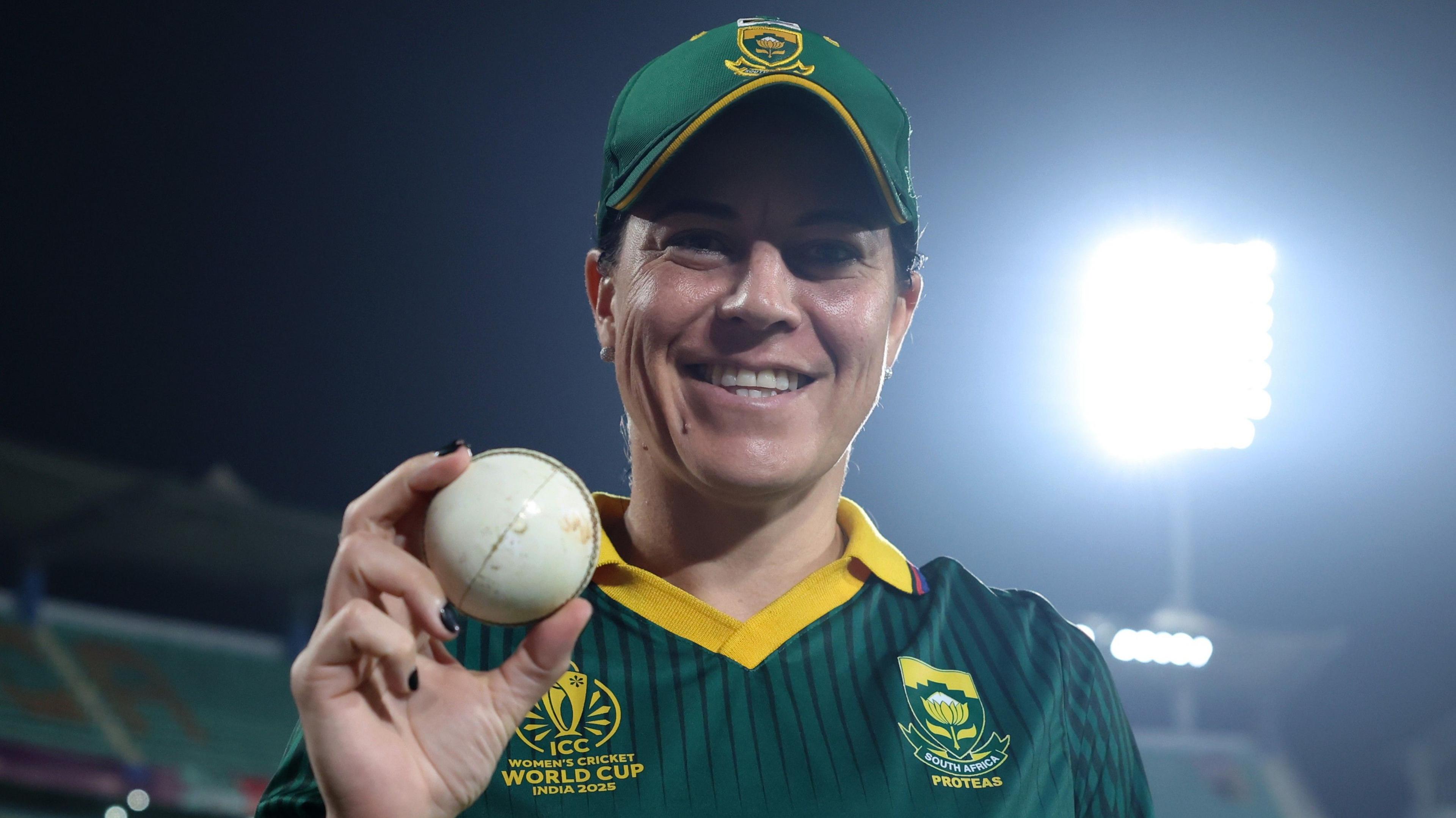 Marizanne Kapp holds the ball aloft after taking five wickets against England