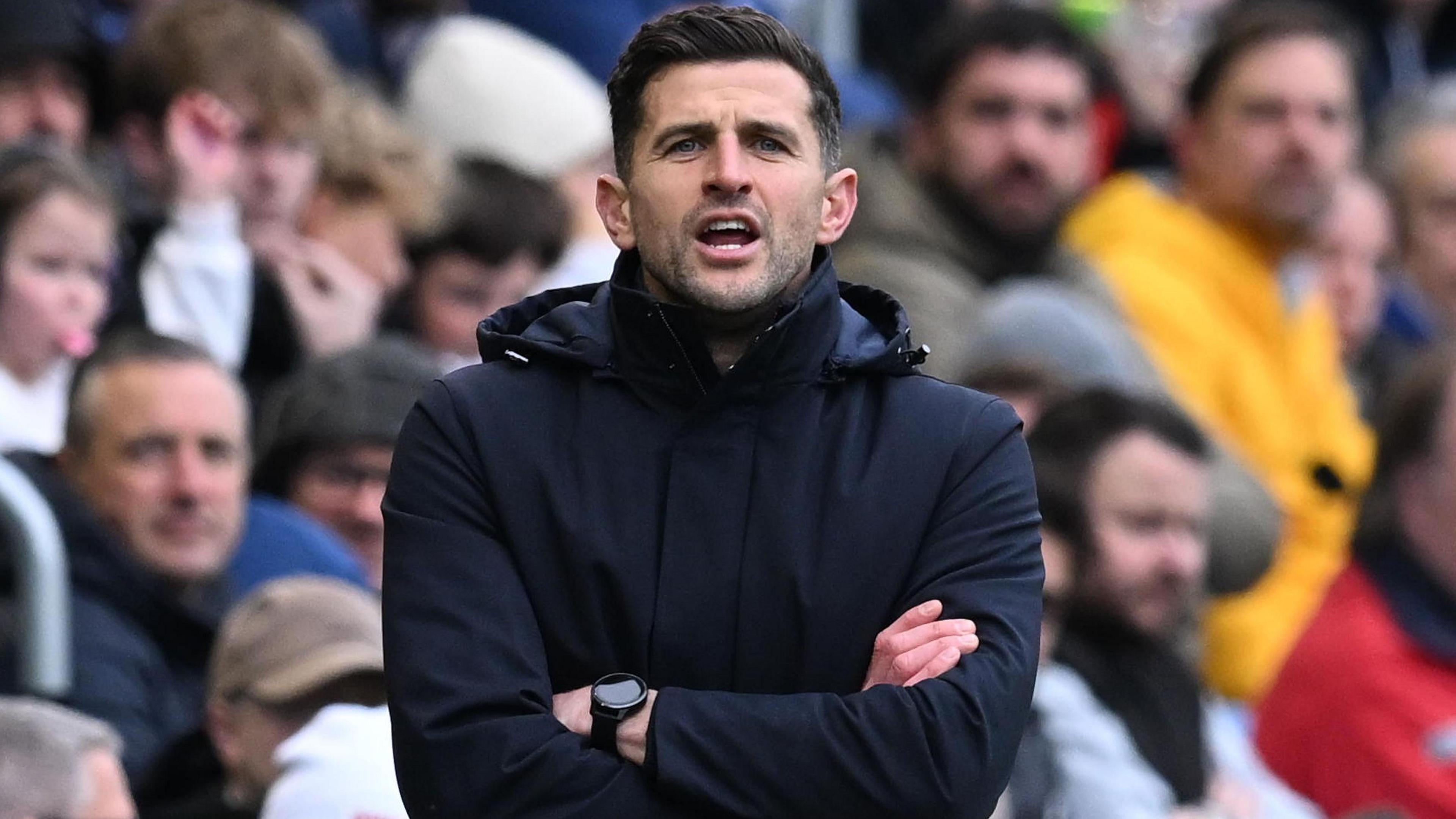 Portsmouth manager John Mousinho shouts instructions from the touchline