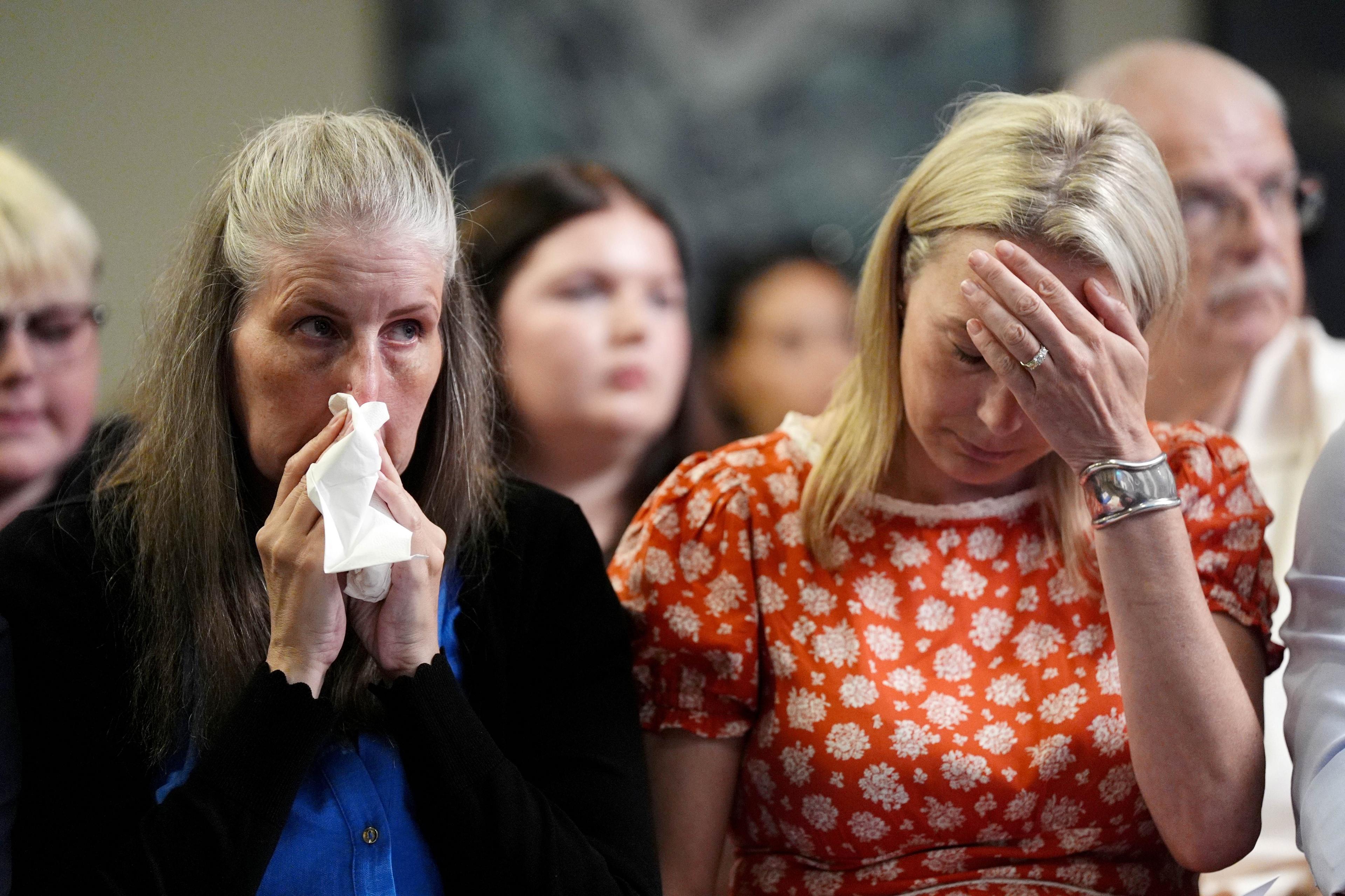 Sarah Hawkins holds a insubstantial   to her look   and appears tearful. Sarah Hawkins, sitting adjacent  to her, holds her manus  to her forehead.